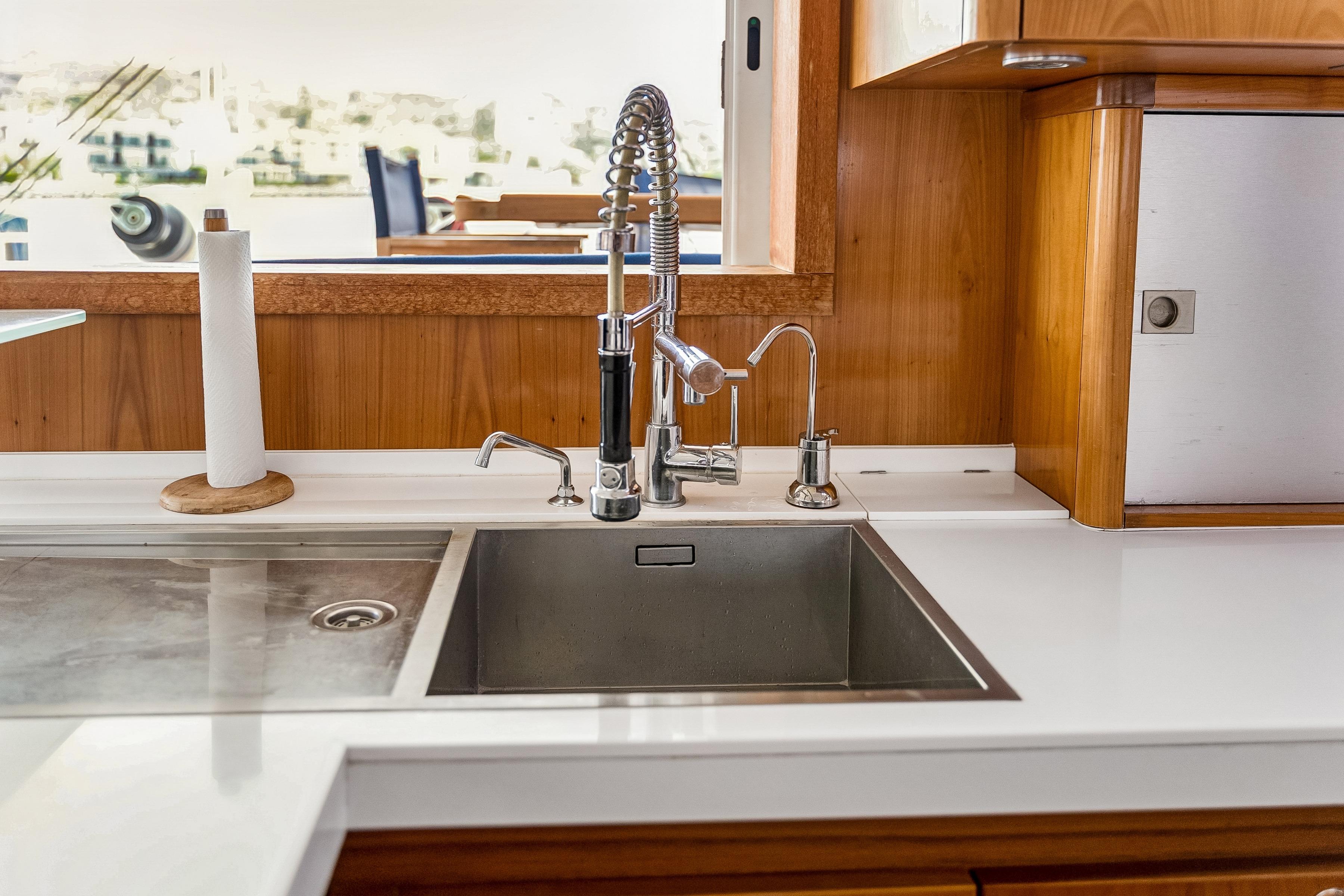 Modern kitchen sink with stainless steel faucet on Catana 65 yacht, 2009 model.