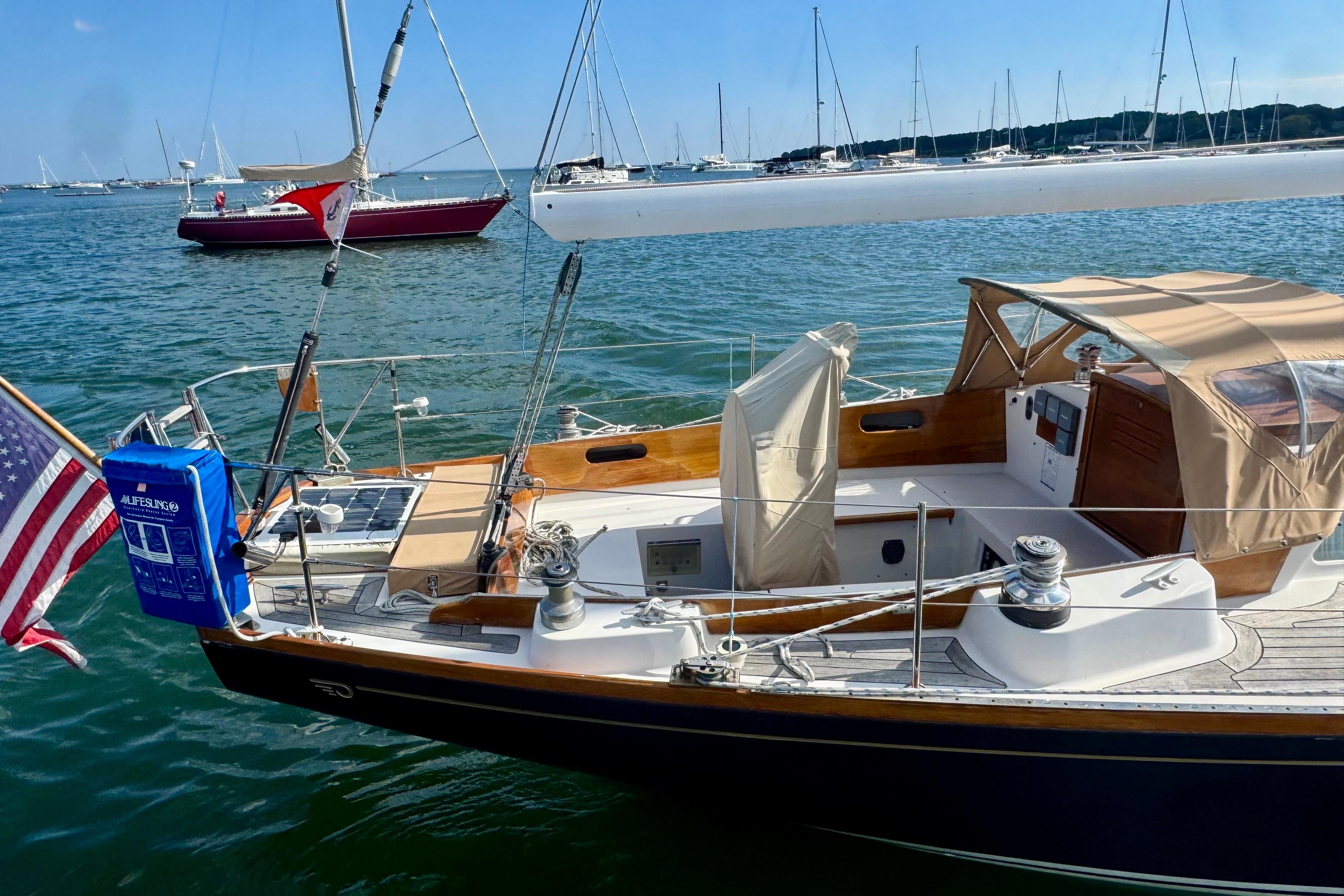 Hinckley Bermuda 40 MK III sailboat, 1982 model, docked in a marina with American flag.