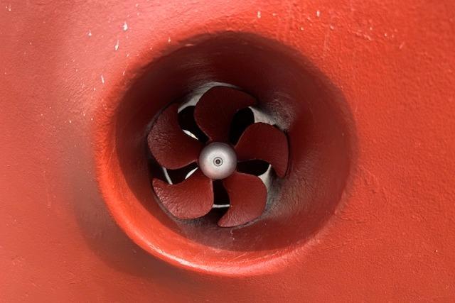 Red propeller of a 1986 Kadey-Krogen 42 boat, close-up view.