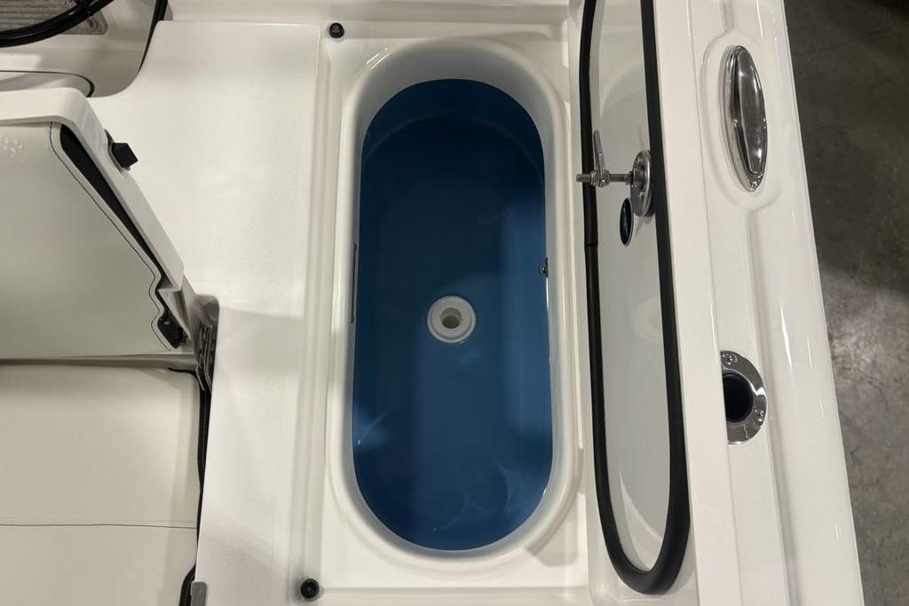 Livewell on 2026 Tidewater 2300 Carolina Bay boat, featuring a blue interior.
