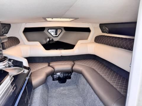 Interior of a 1992 Fountain Fever boat, featuring cushioned seating and modern design.