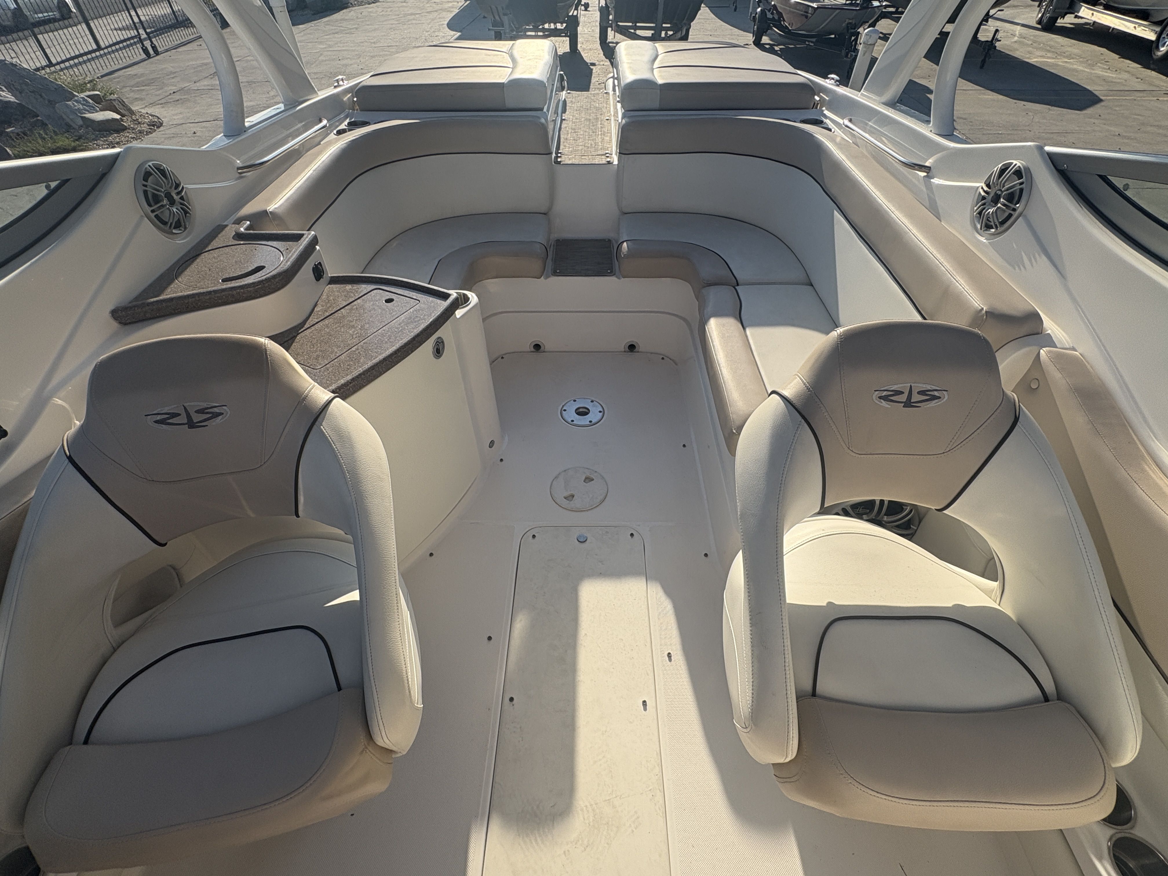 2013 Rinker Captiva 276 boat interior with beige seating and storage compartments.