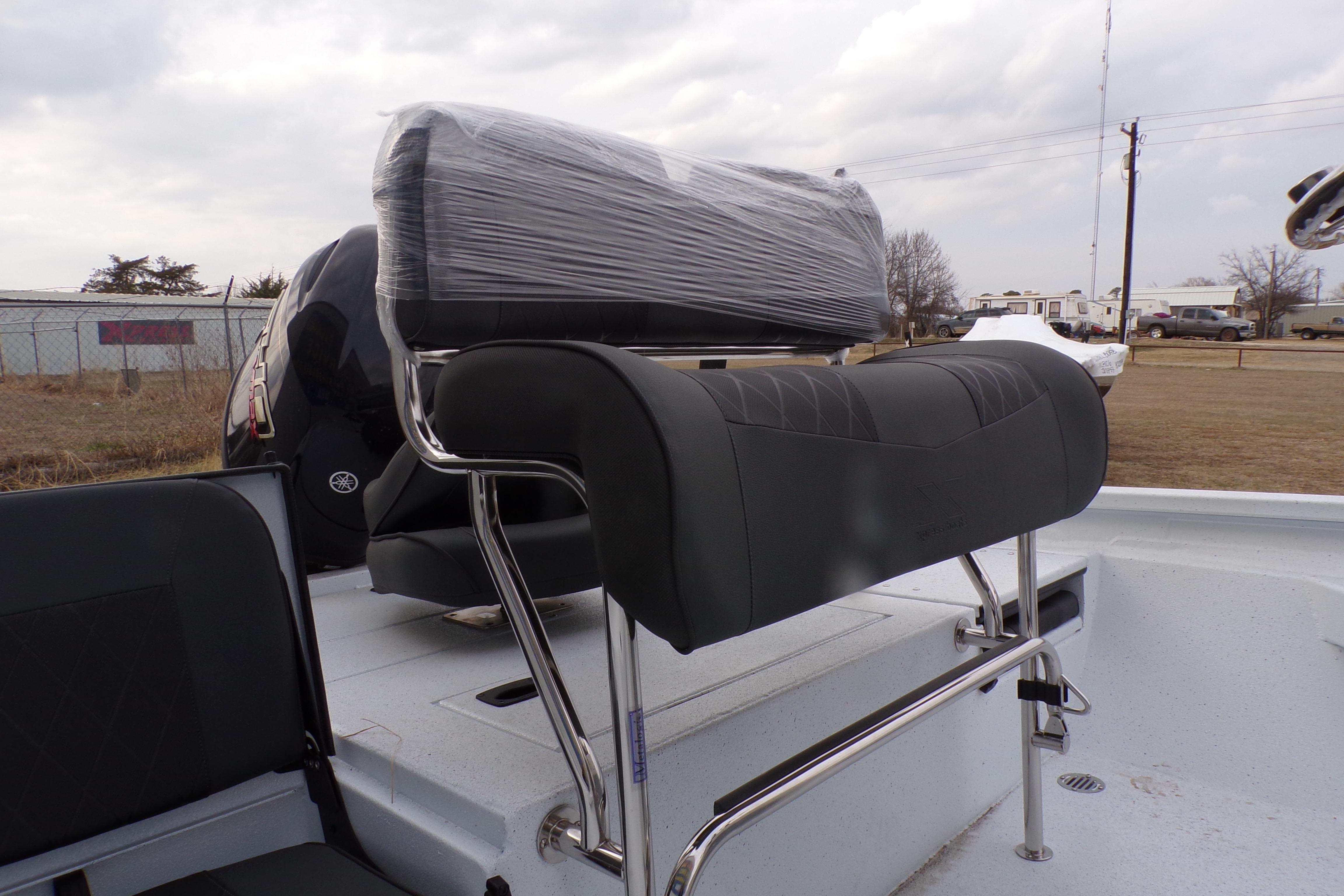2026 Xpress H20B Bay boat with sleek seating and Yamaha engine, parked outdoors.