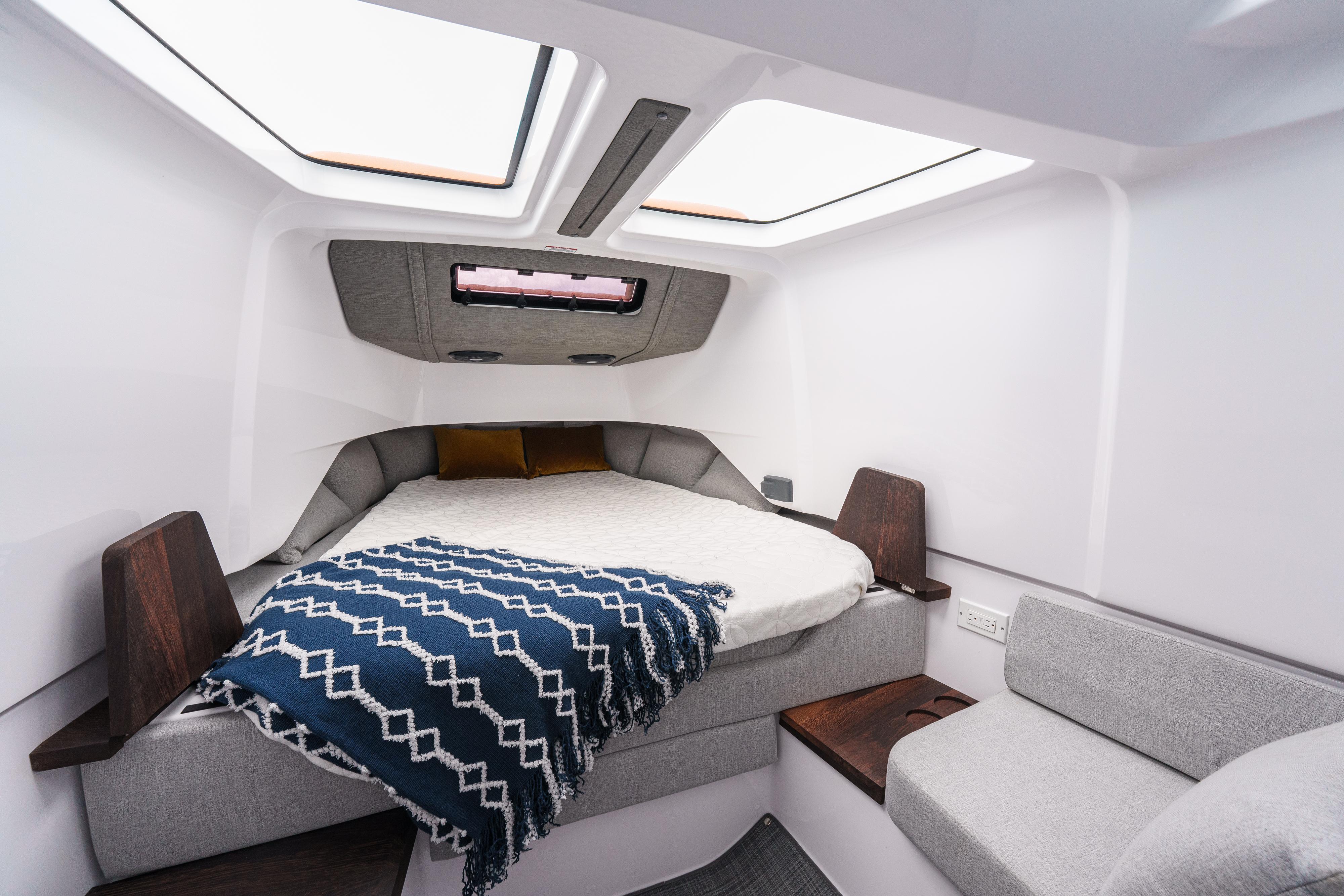 2022 Axopar 37 XC CROSS CABIN interior with cozy bed and modern design.