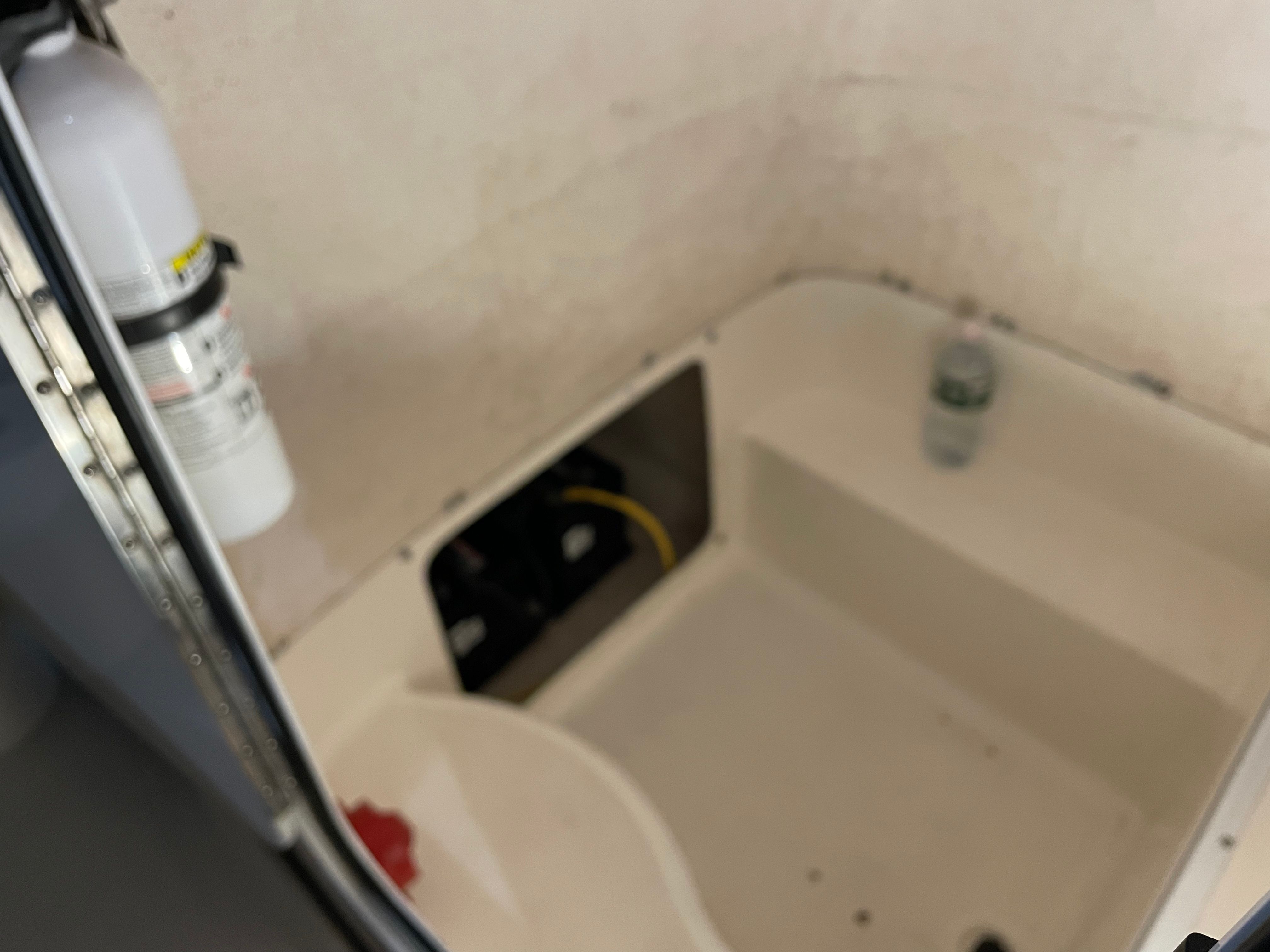 Interior of a 2005 Aquasport 210 Osprey boat with fire extinguisher.