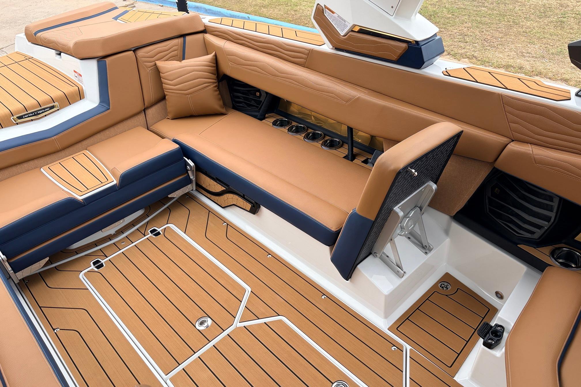 Luxurious interior of 2026 Nautique Super Air Nautique G25 boat with tan and navy seating.