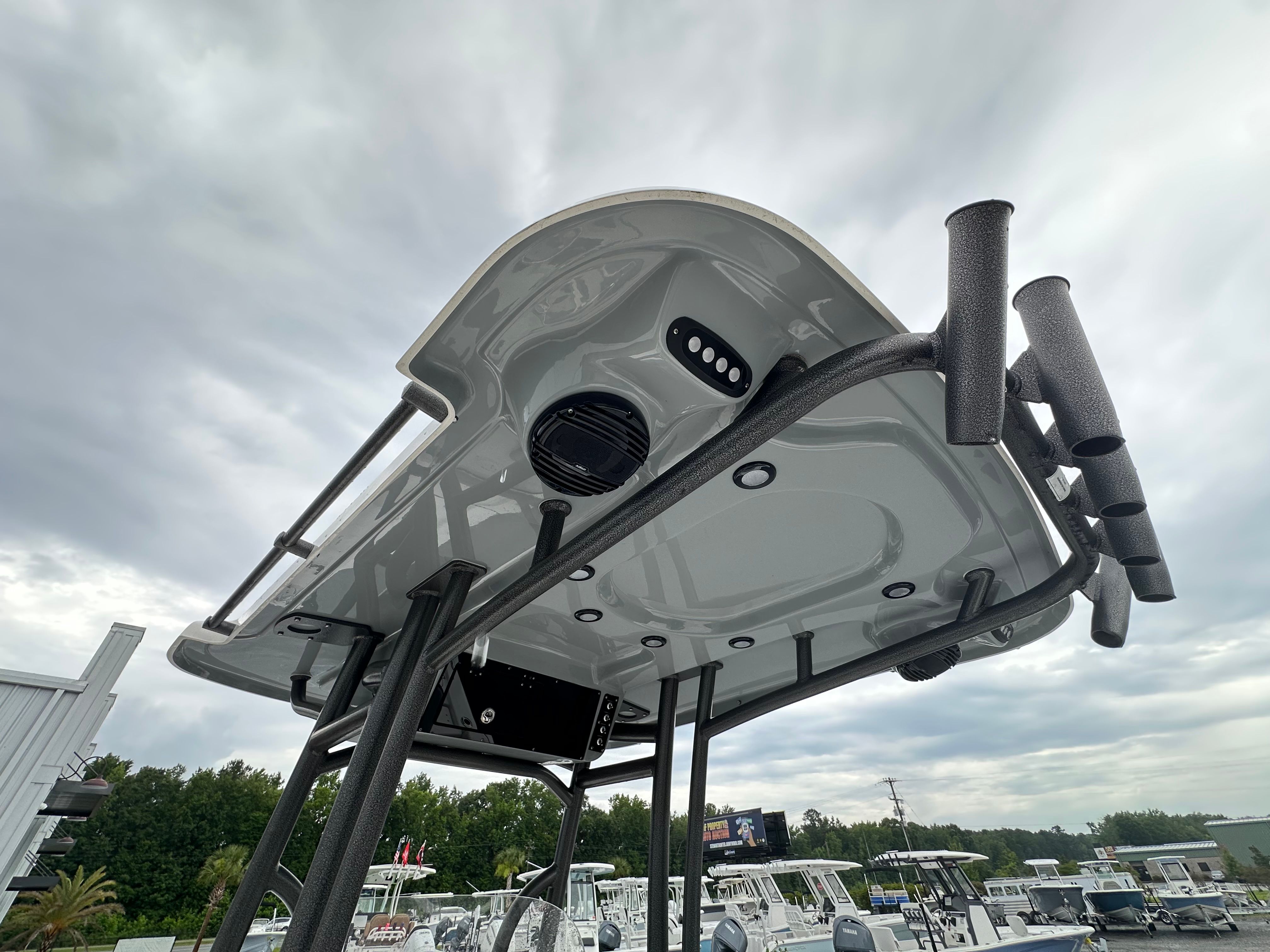 View of a Sea Pro 230 DLX boat roof with rod holders and speakers.