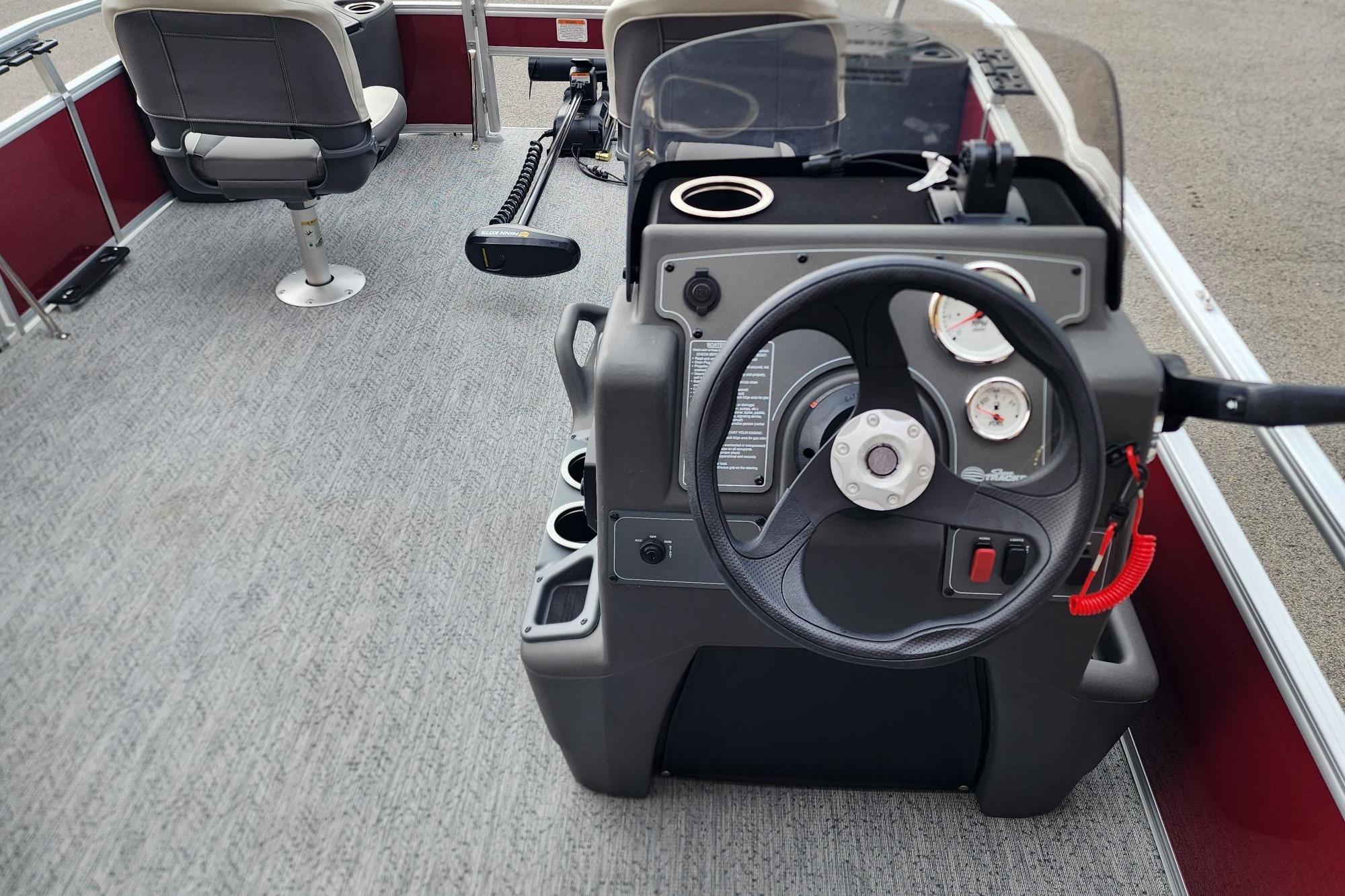 2026 Sun Tracker Bass Buggy 18 DLX boat interior with steering console and seating.