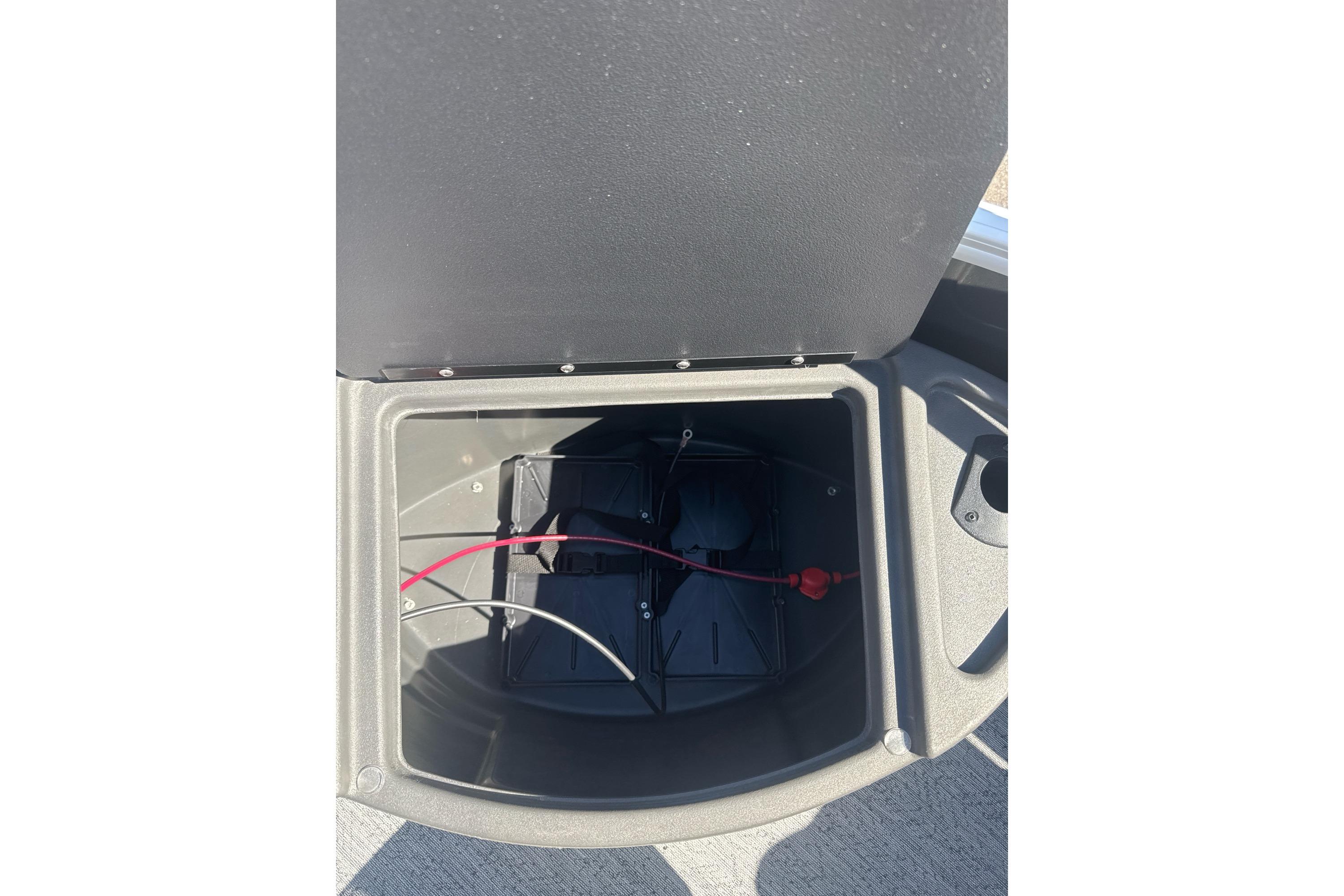 Open storage compartment on 2026 Sun Tracker Fishin' Barge 20 DLX boat.