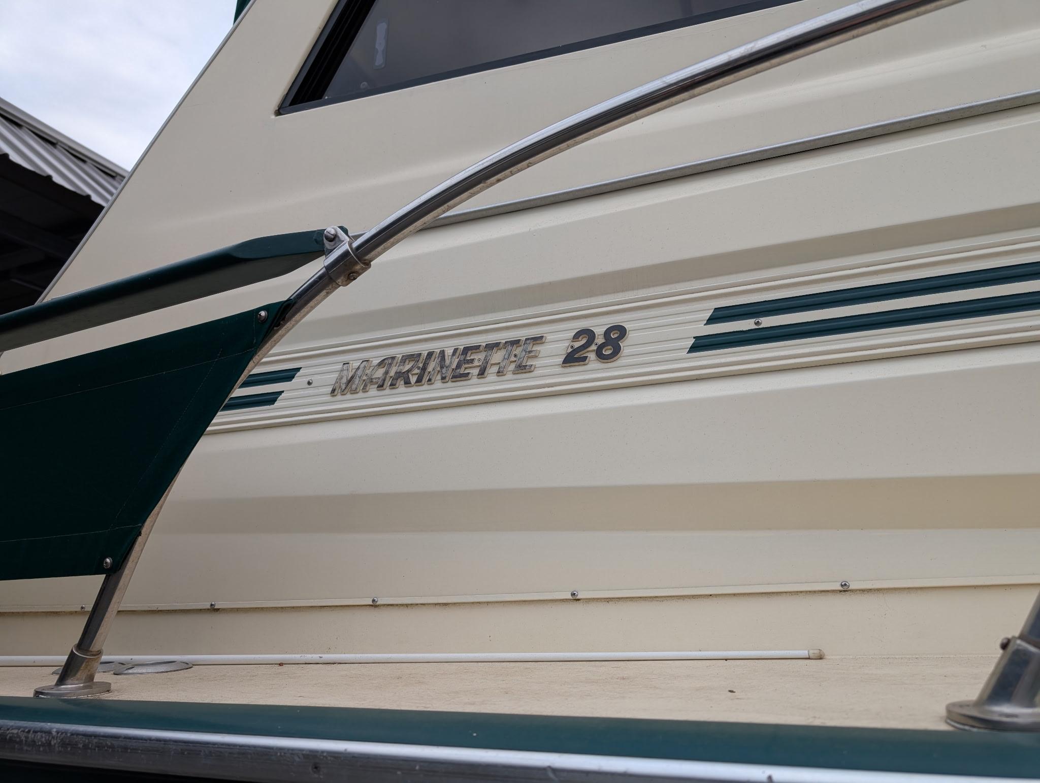 1989 Marinette 28 Sport Fish Fly Bridge boat exterior with nameplate detail.