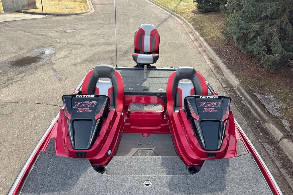 2026 Nitro Z20 XL Pro boat with red and gray seating, parked on a road.