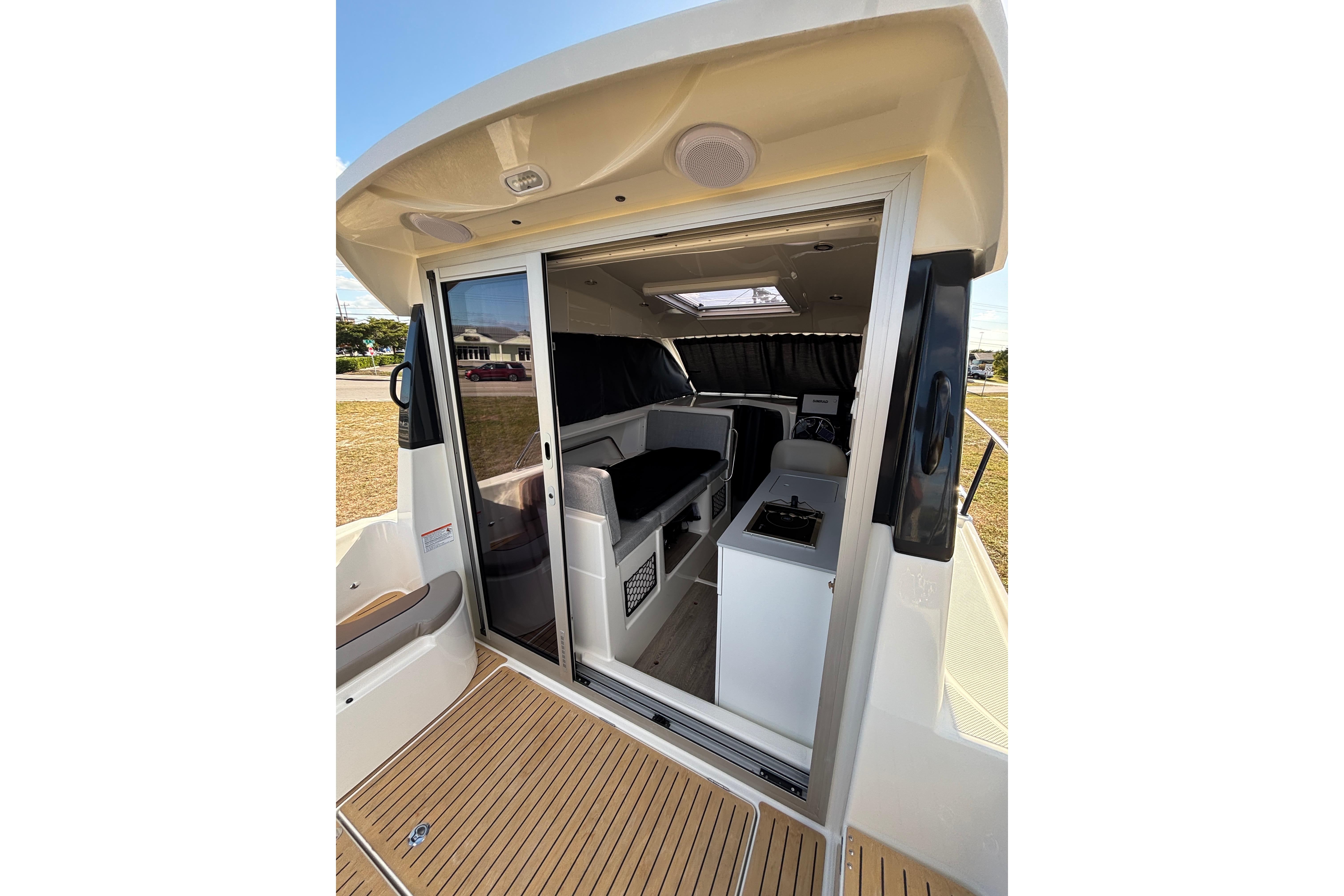 2026 Trophy T 25 Explorer boat interior with sliding door and seating area.