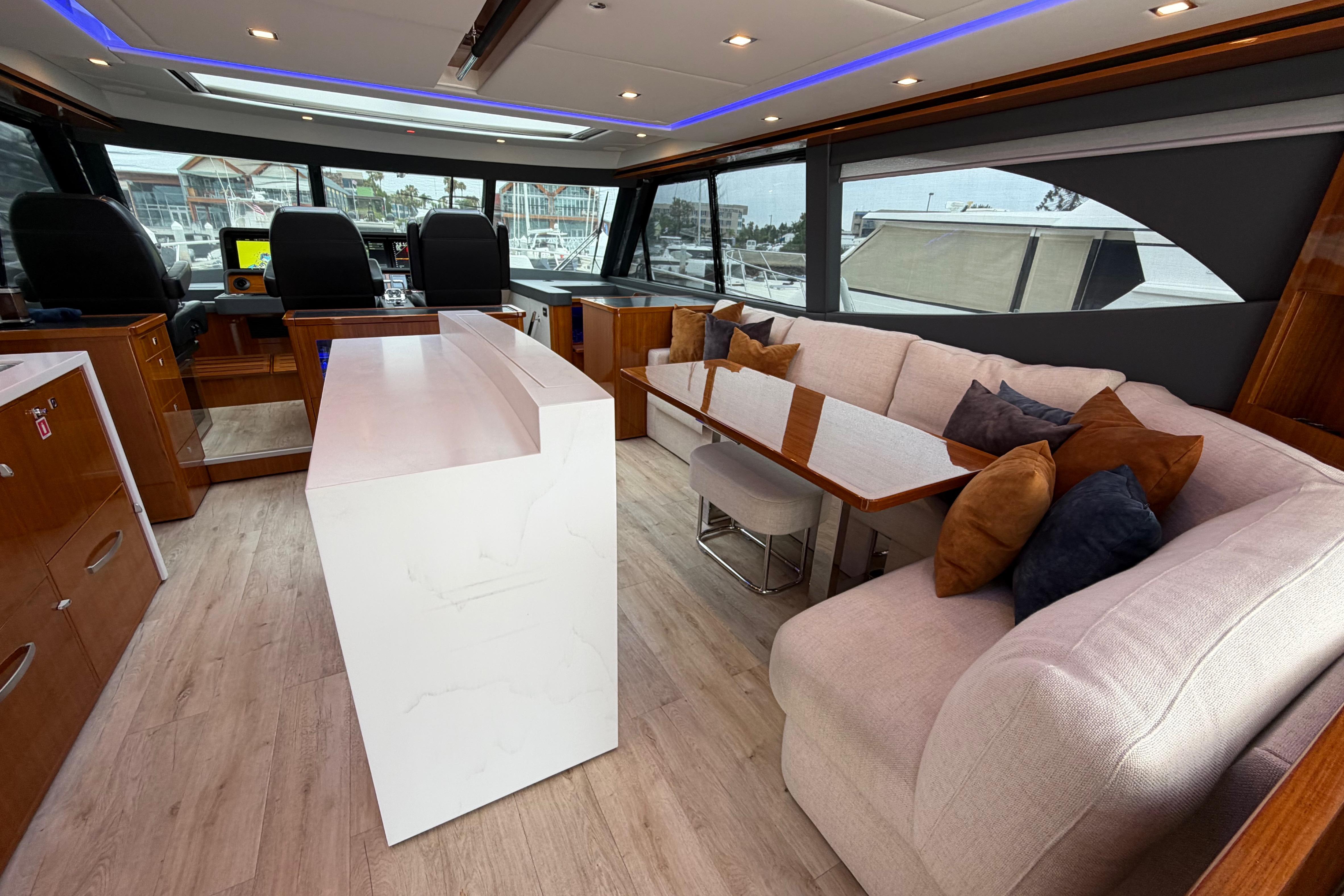 Luxurious interior of 2023 Riviera 645 SUV yacht with modern seating and elegant design.