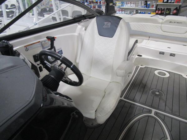 2017 Larson 292 LXI boat interior with steering wheel and seating area.