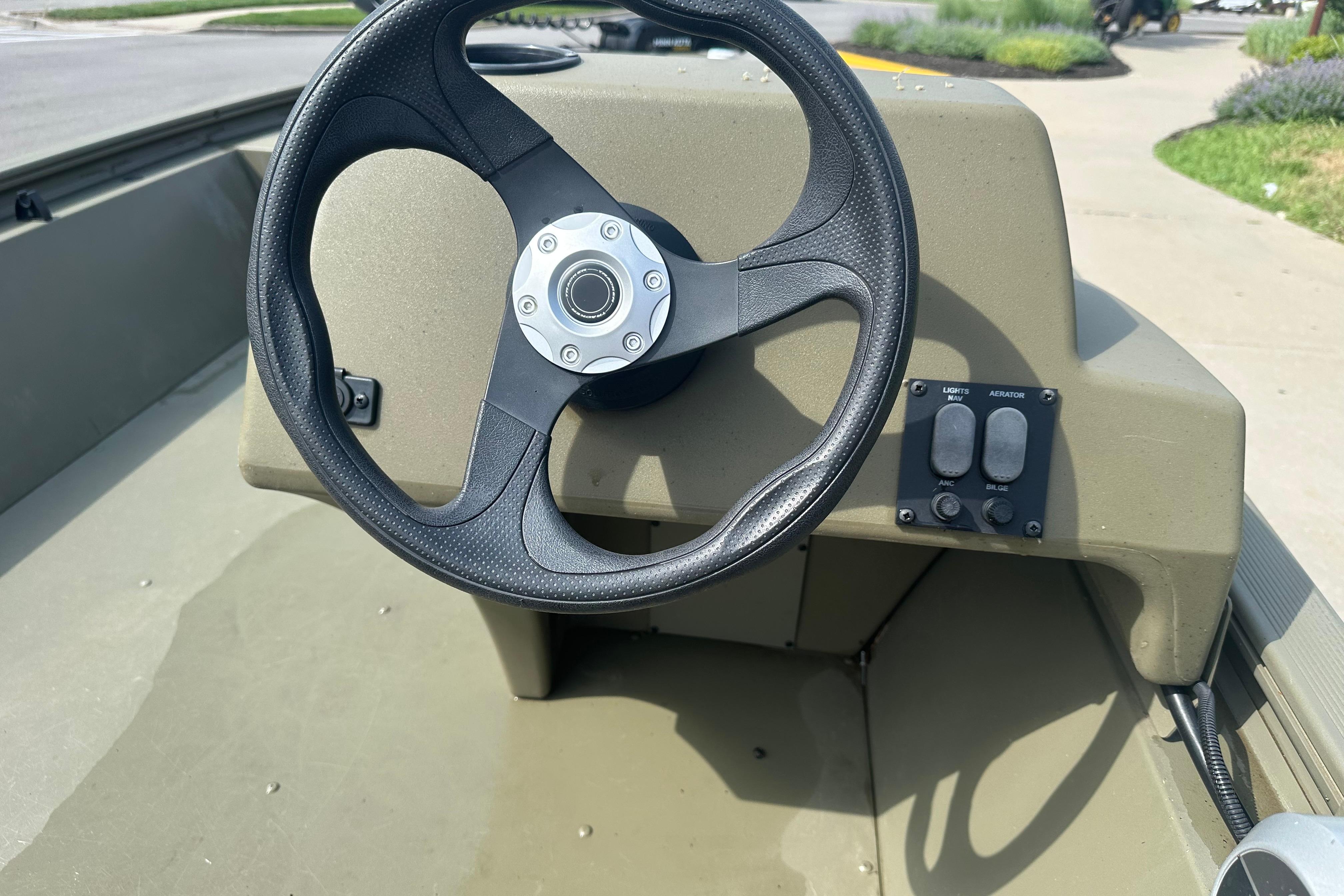Steering wheel of 2024 Tracker Grizzly 1648 SC boat, featuring control panel.