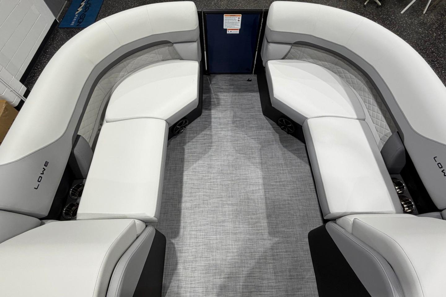 Luxurious seating on 2026 Lowe SS 230 WT pontoon boat, featuring elegant white upholstery.