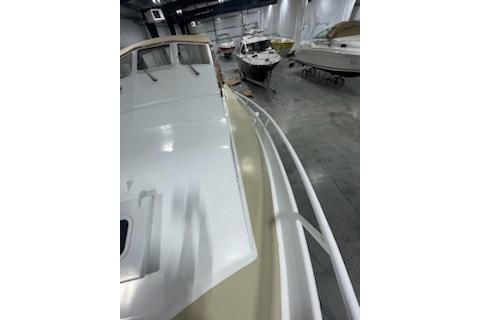 1964 Striker Model 120 boat in storage, surrounded by other vessels.