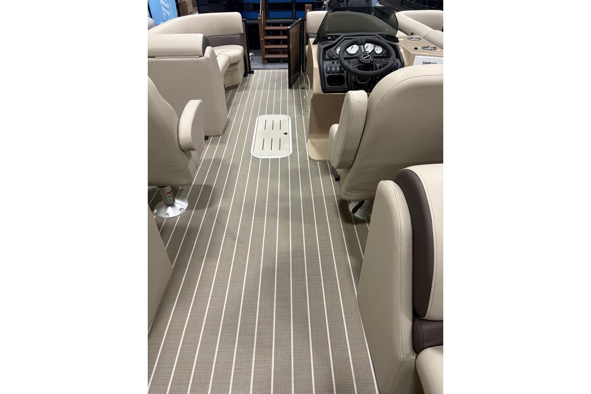 2026 Bentley Pontoons Legacy 223 Navigator interior with beige seating and striped flooring.
