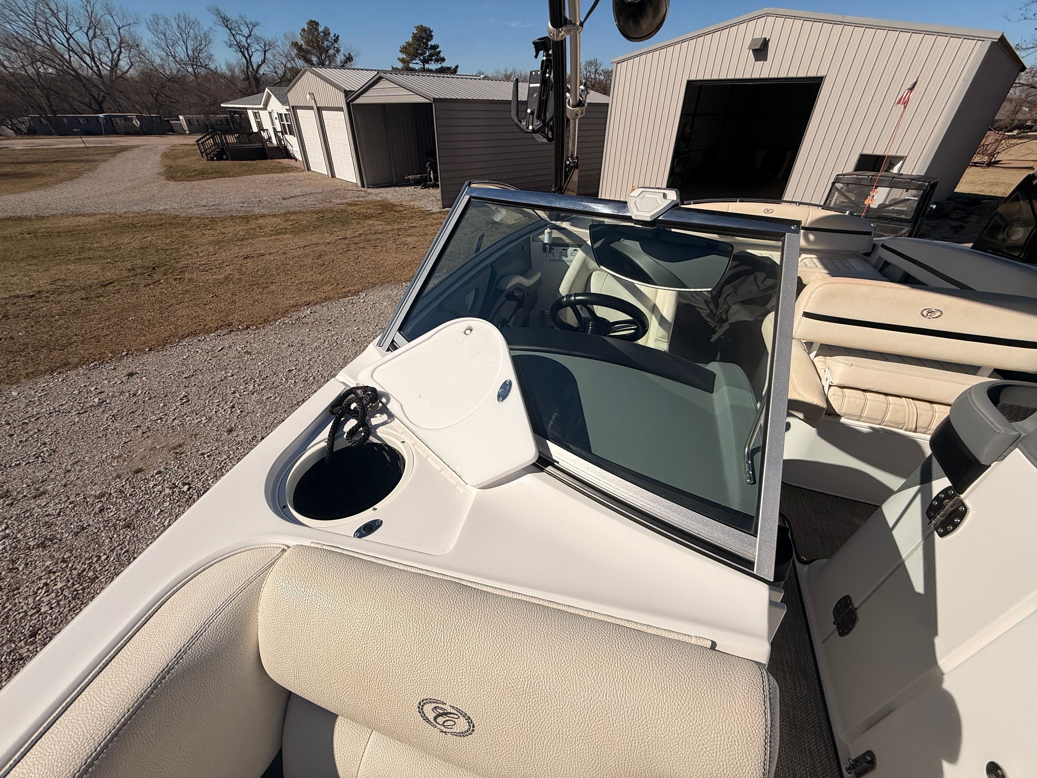 The image shows the cockpit of a 2019 Cobalt R7 Surf boat with beige seats and a steering wheel.