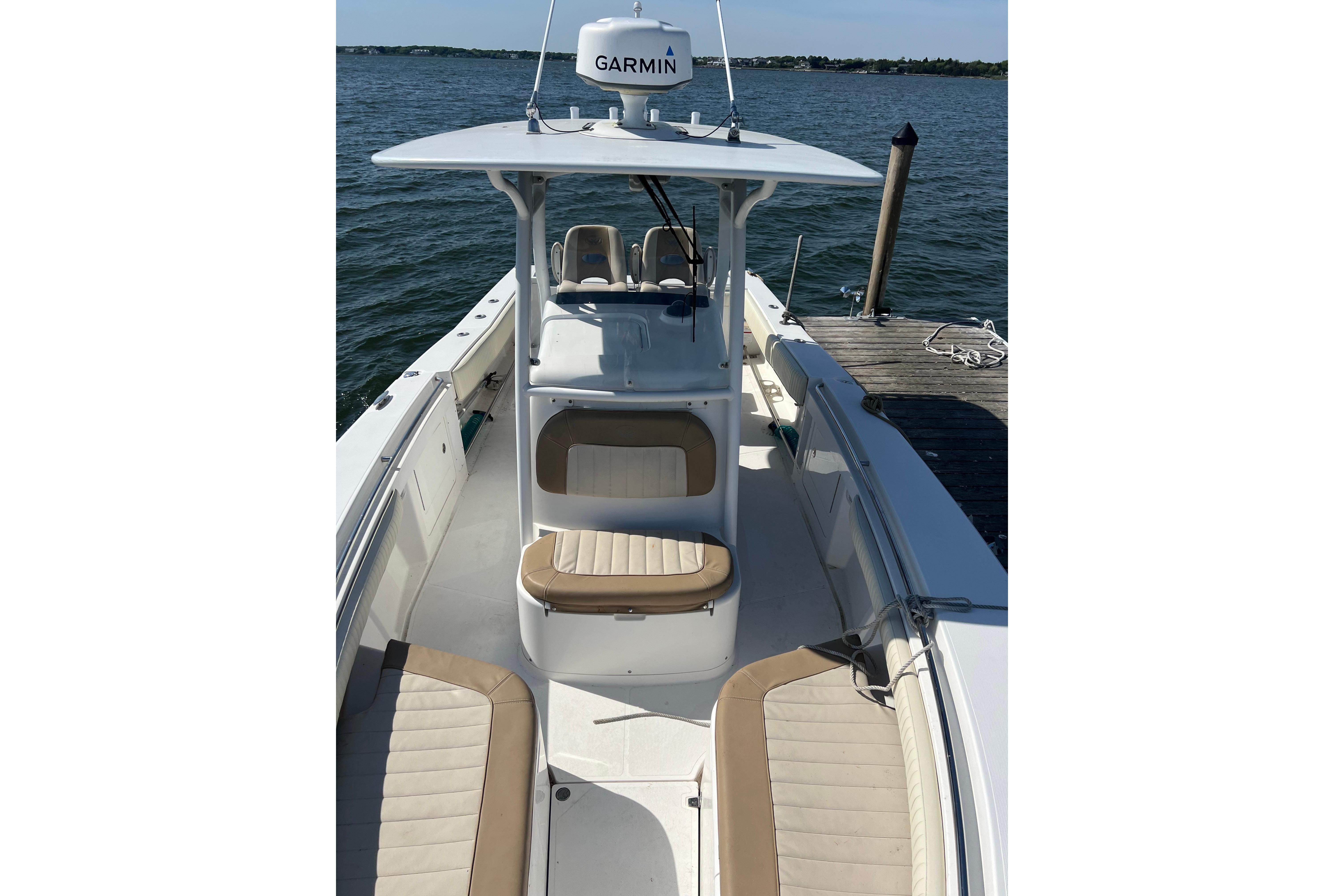 2006 Southport 26 Center Console boat docked, featuring Garmin equipment and spacious seating.