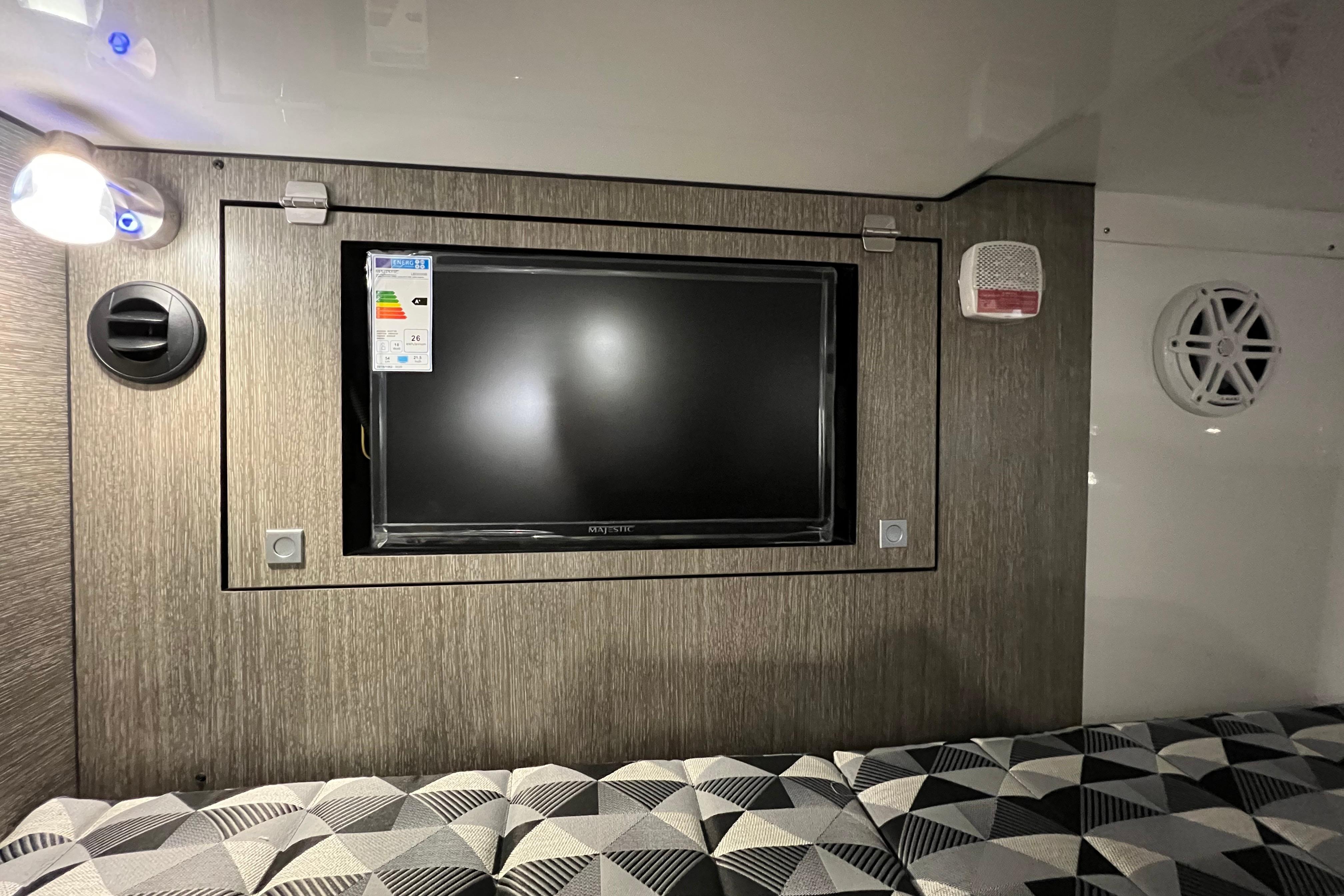 2023 Monterey 378SS Super Sport interior with TV, modern lighting, and geometric-patterned seating.