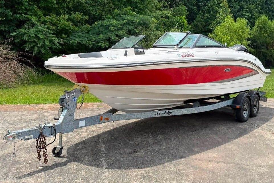 2016 Sea Ray 21 SPX boat on trailer, red and white, parked outdoors.