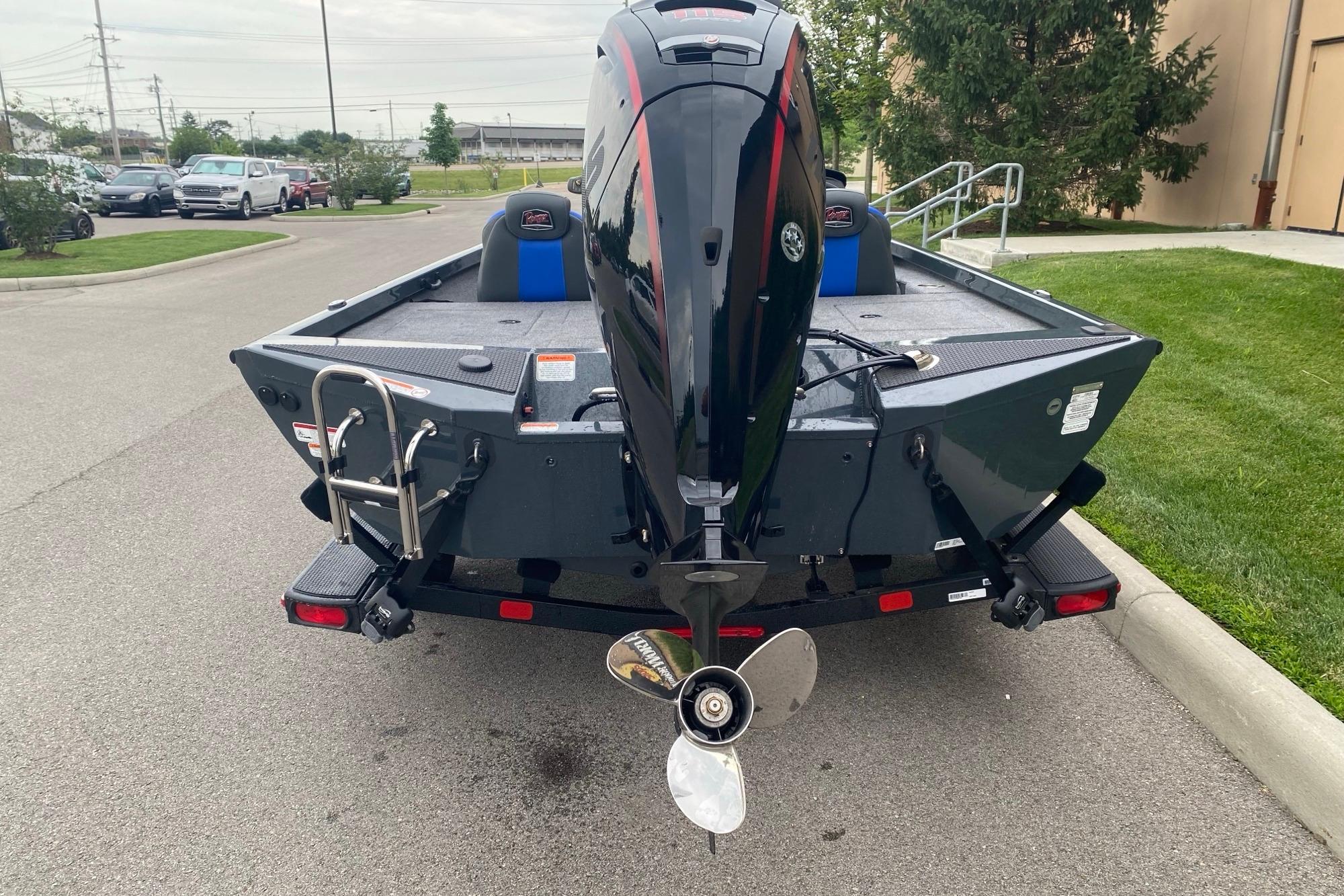 2026 Ranger RT188P boat with outboard motor, parked on a street.