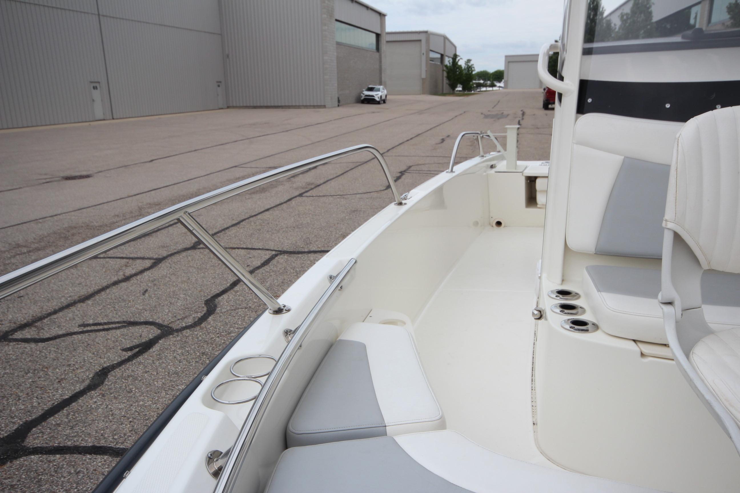 2014 Boston Whaler 210 Dauntless boat interior with seating and cup holders.