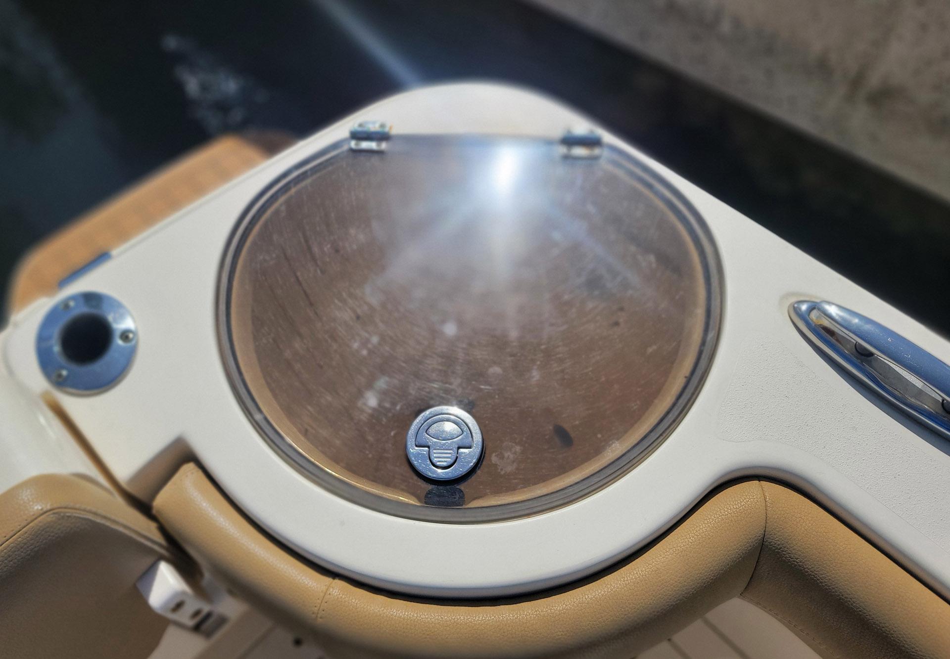 2018 Scout 275 LXF boat detail with circular hatch and beige seating.