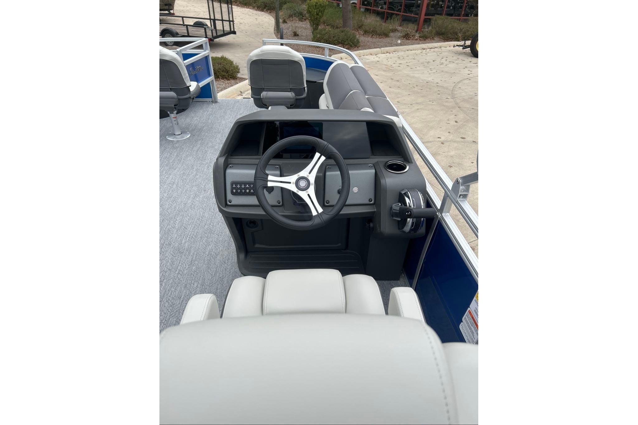 2026 Sun Tracker Fishin' Barge 20 DLX steering console with modern controls and seating.