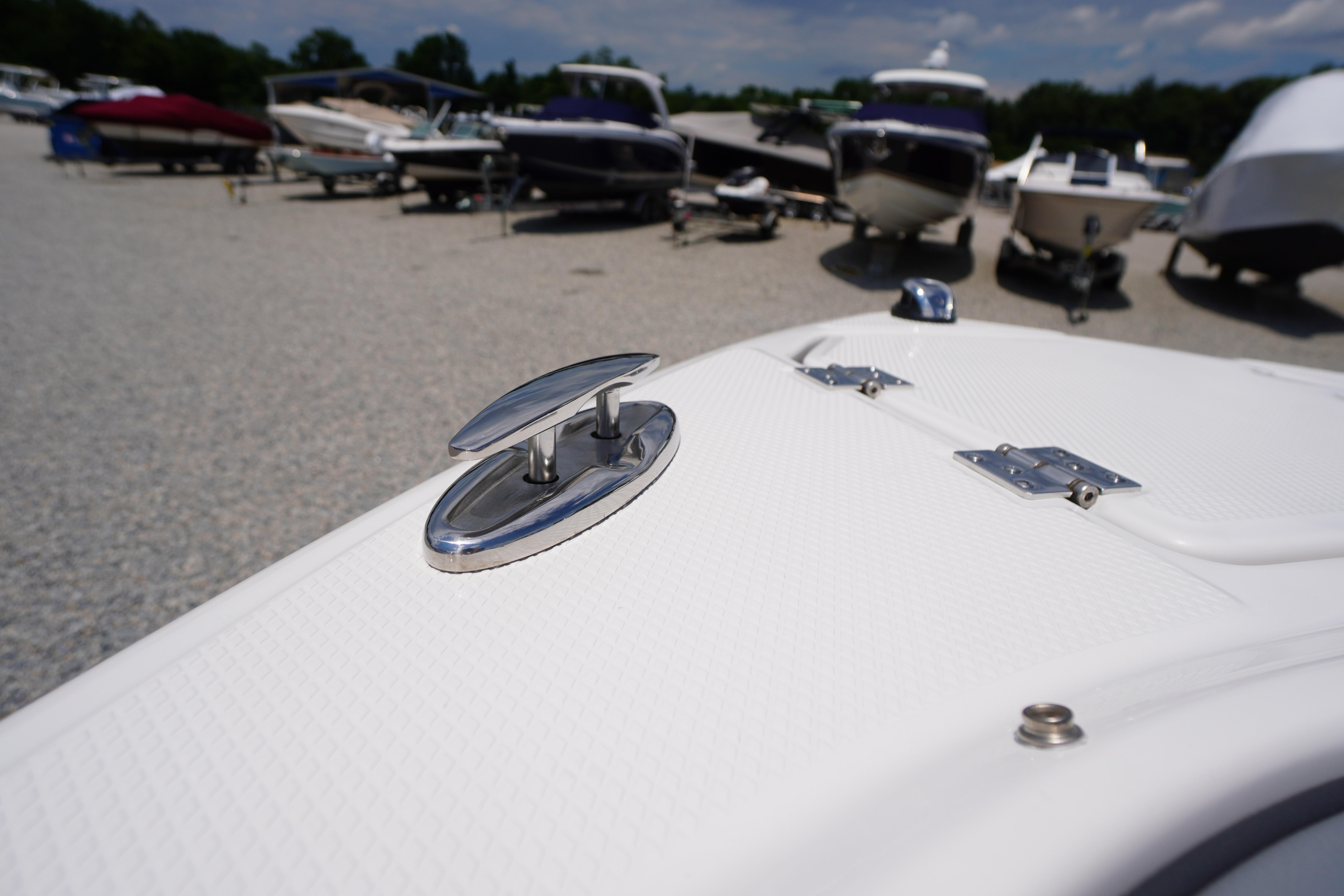 2026 Chaparral SSX 4 boat detail with cleat, surrounded by other boats in a marina.