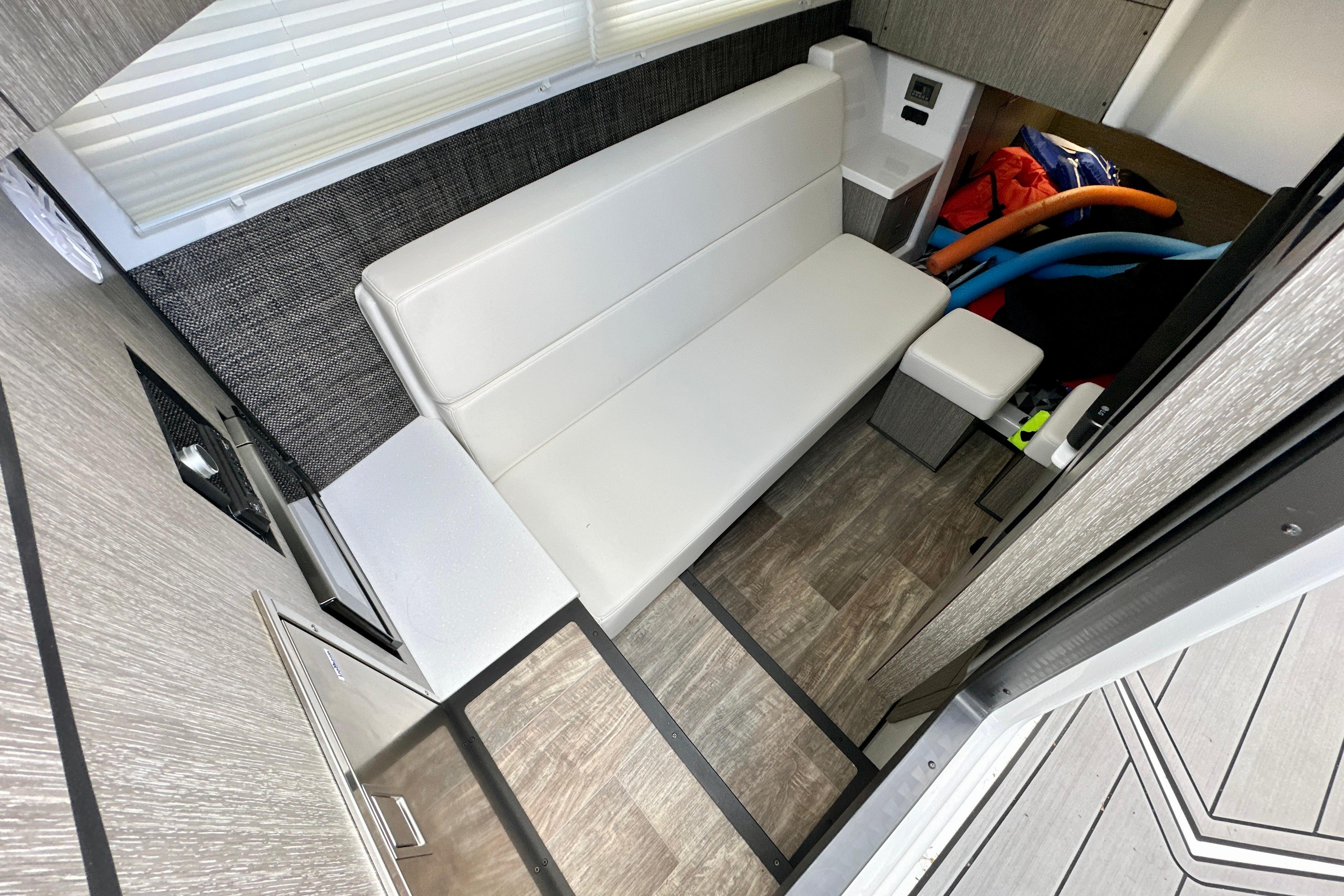 Interior of 2022 Monterey 378SS Super Sport boat with white seating and storage area.