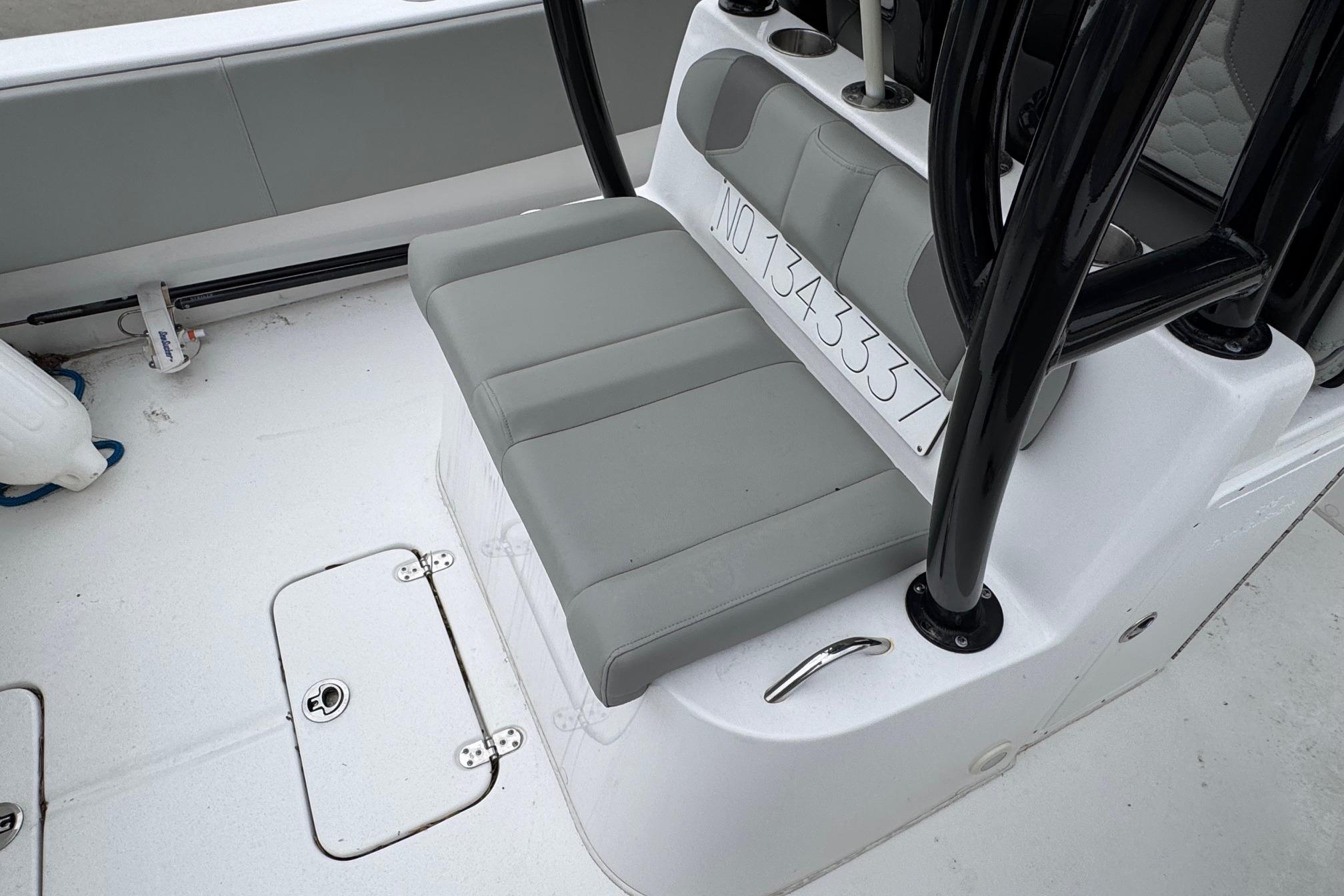 2024 Cape Horn 32 XS boat interior with gray seating and storage compartments.