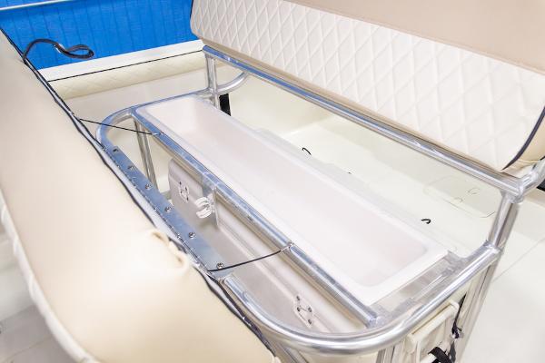 Manufacturer Provided Image: 2026 Carolina Skiff 23 LS boat seating with storage compartment, featuring beige upholstery and stainless steel frame.