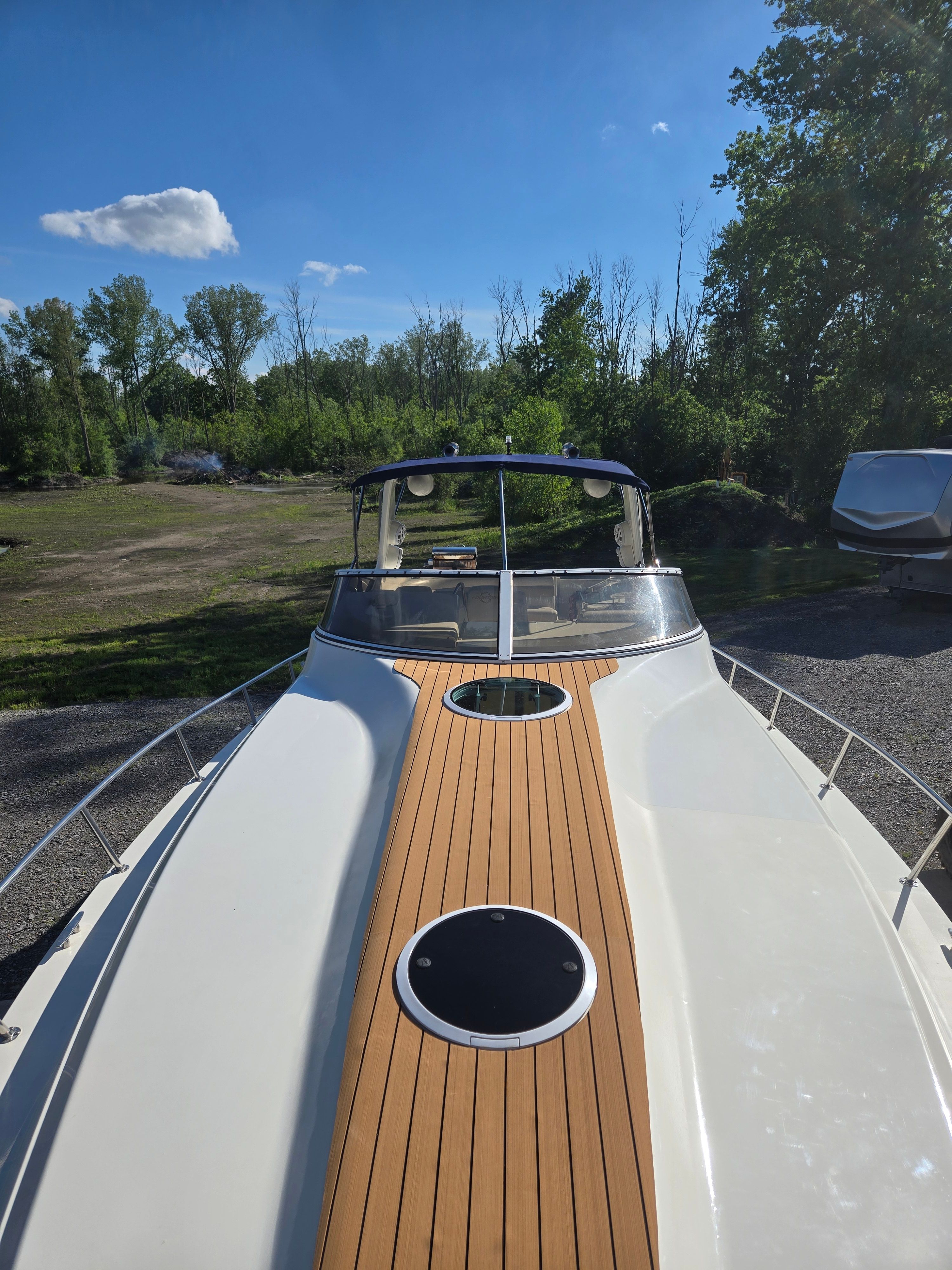 Fountain 38 Express Cruiser 2004 on land with wooden deck.