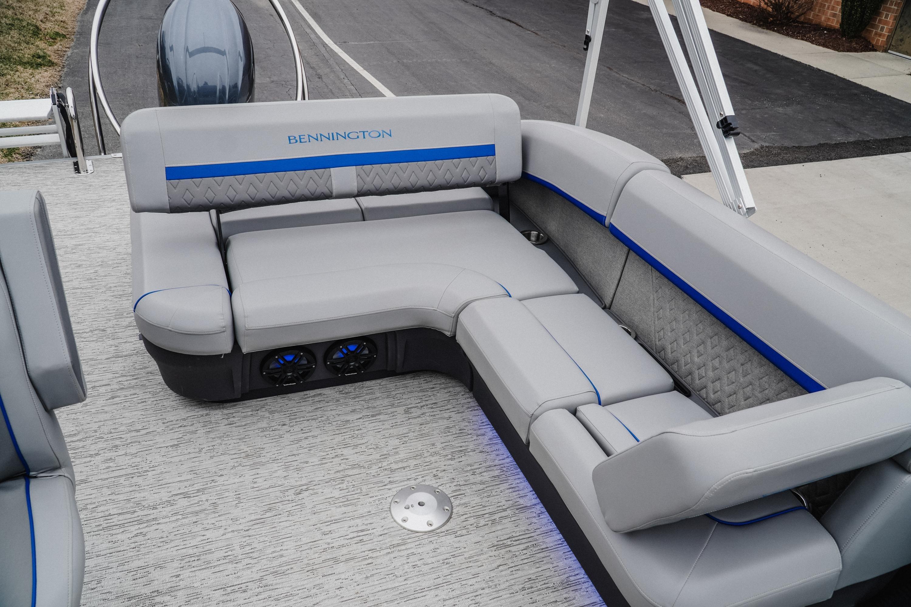 2025 Bennington 24MSB boat interior with gray seating and blue accents.