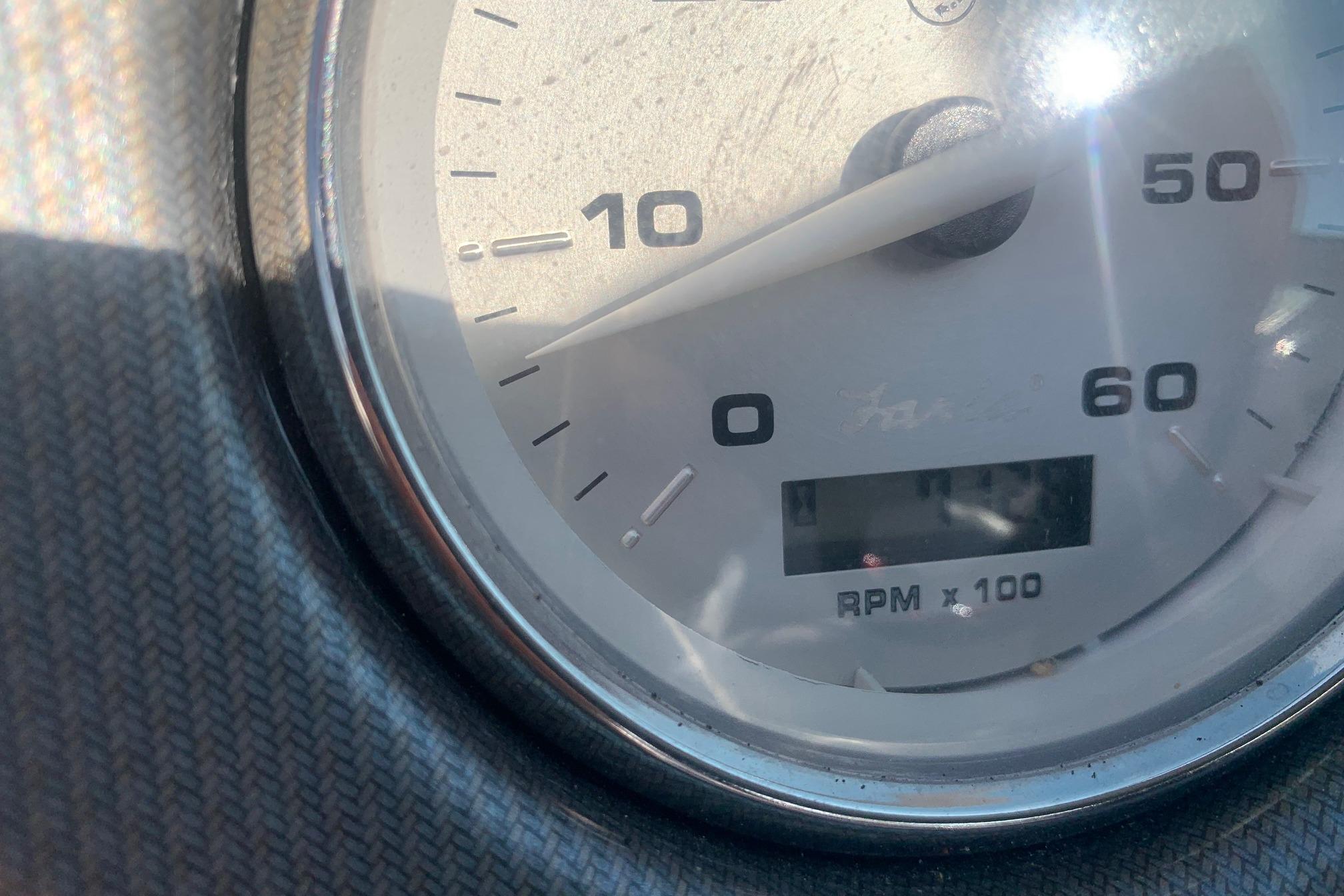 Close-up of a tachometer on a 2006 Rinker 282 Captiva Cuddy boat.