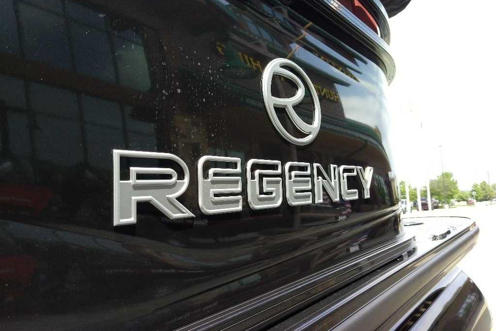 2026 Regency 230 DL logo on sleek black surface, showcasing modern design.