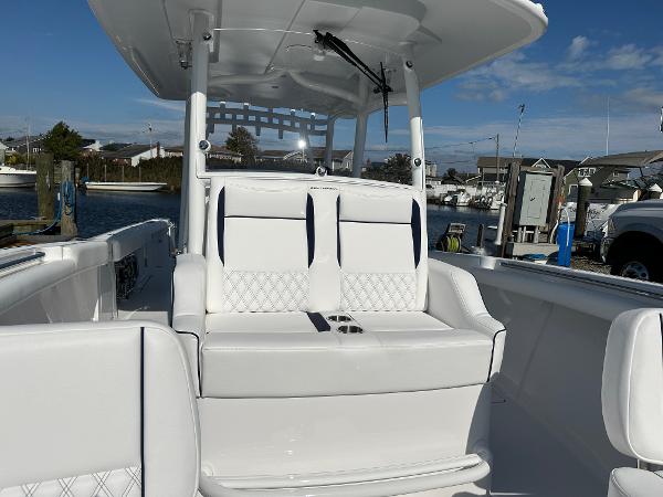 2025 Southport 33 FE boat with white seating and sleek design at a marina.
