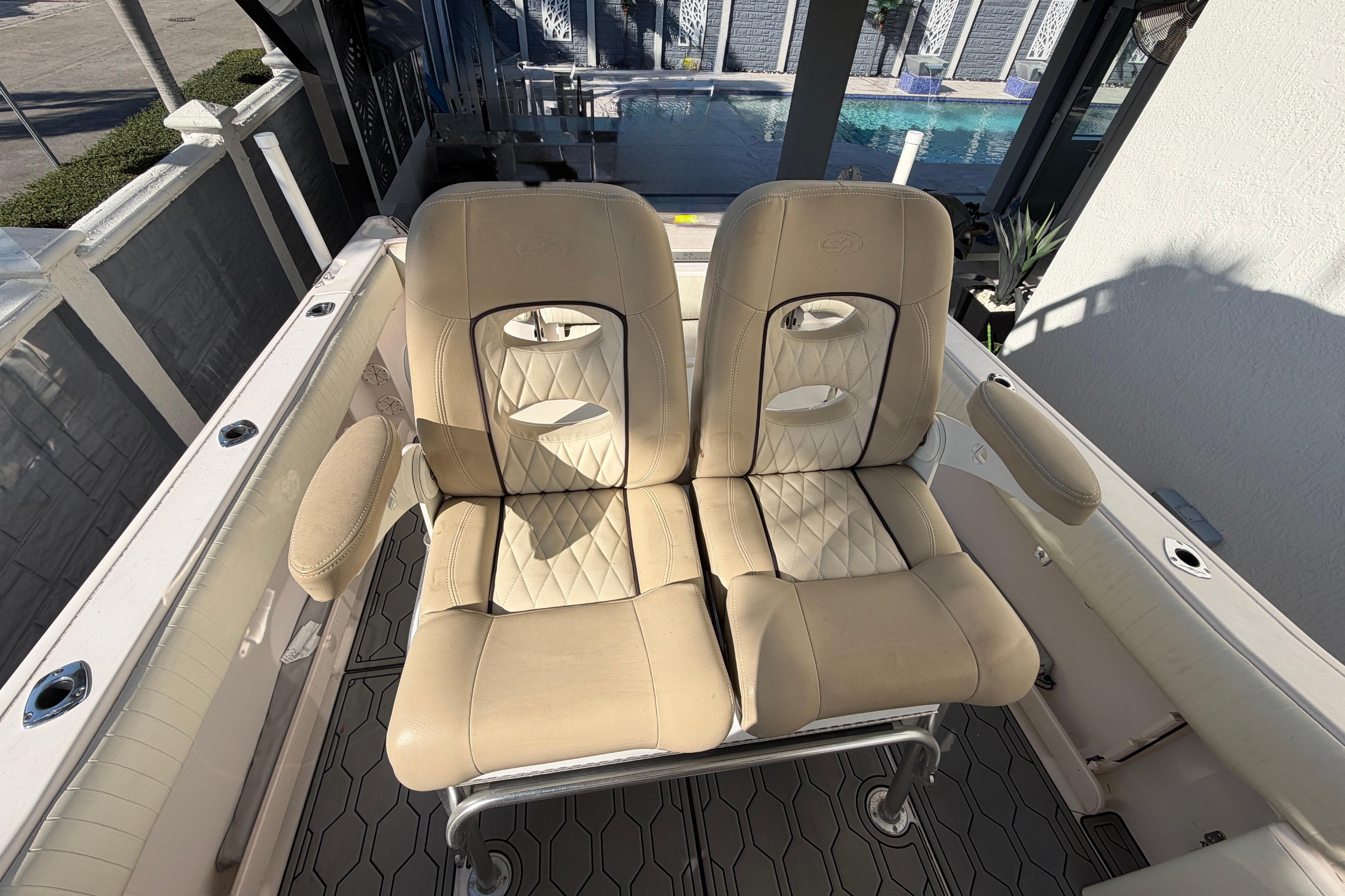 2004 Grady White 273 boat seats with beige upholstery and diamond stitching.