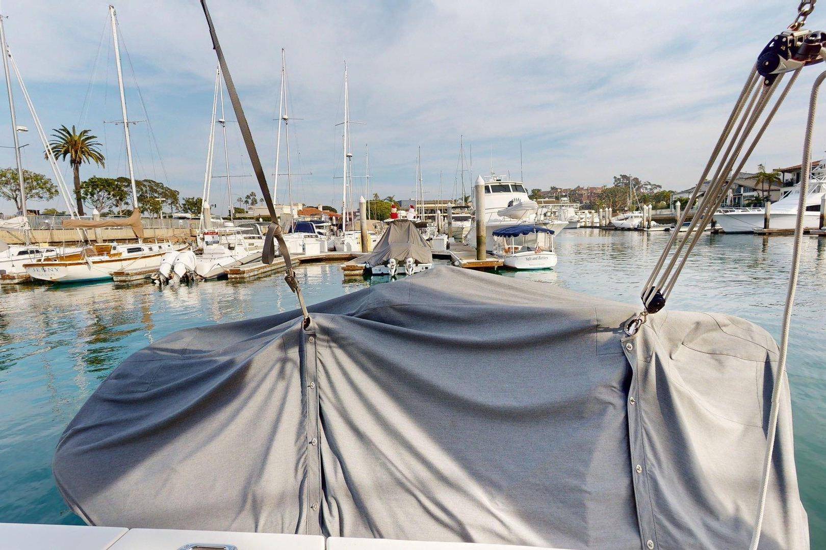 2021 Beneteau Swift Trawler 35 docked in a marina, covered with a protective tarp.