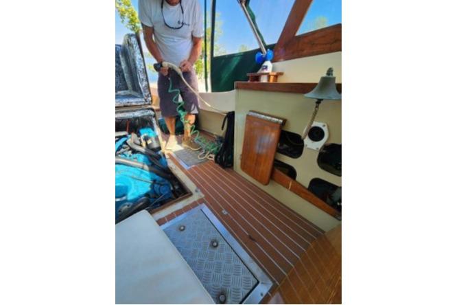 1985 Wasque Down East Cruiser interior with wooden flooring and nautical equipment.