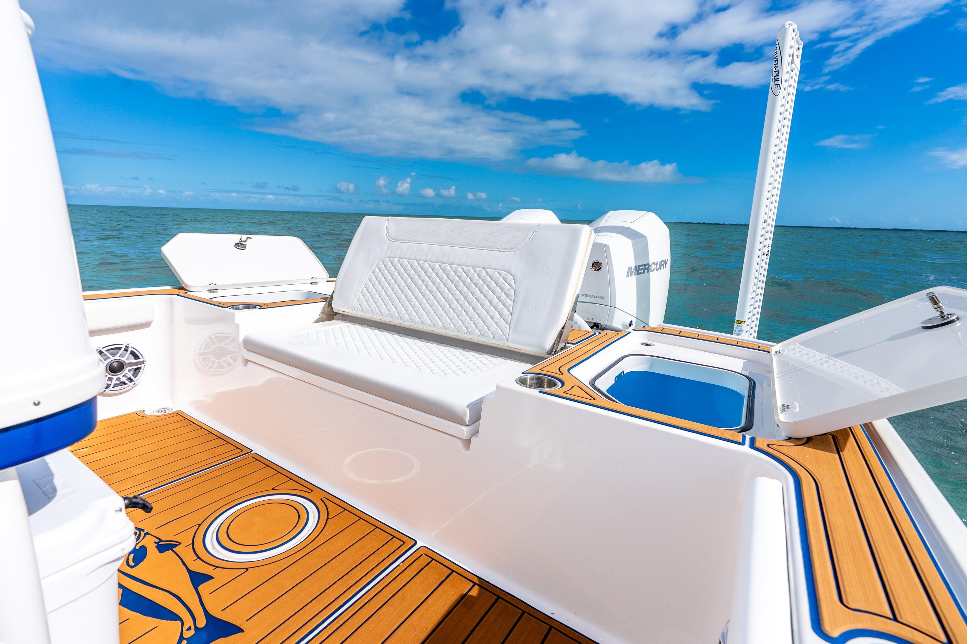 2024 Caymas 281 HB boat interior with seating, ocean view, and blue sky.