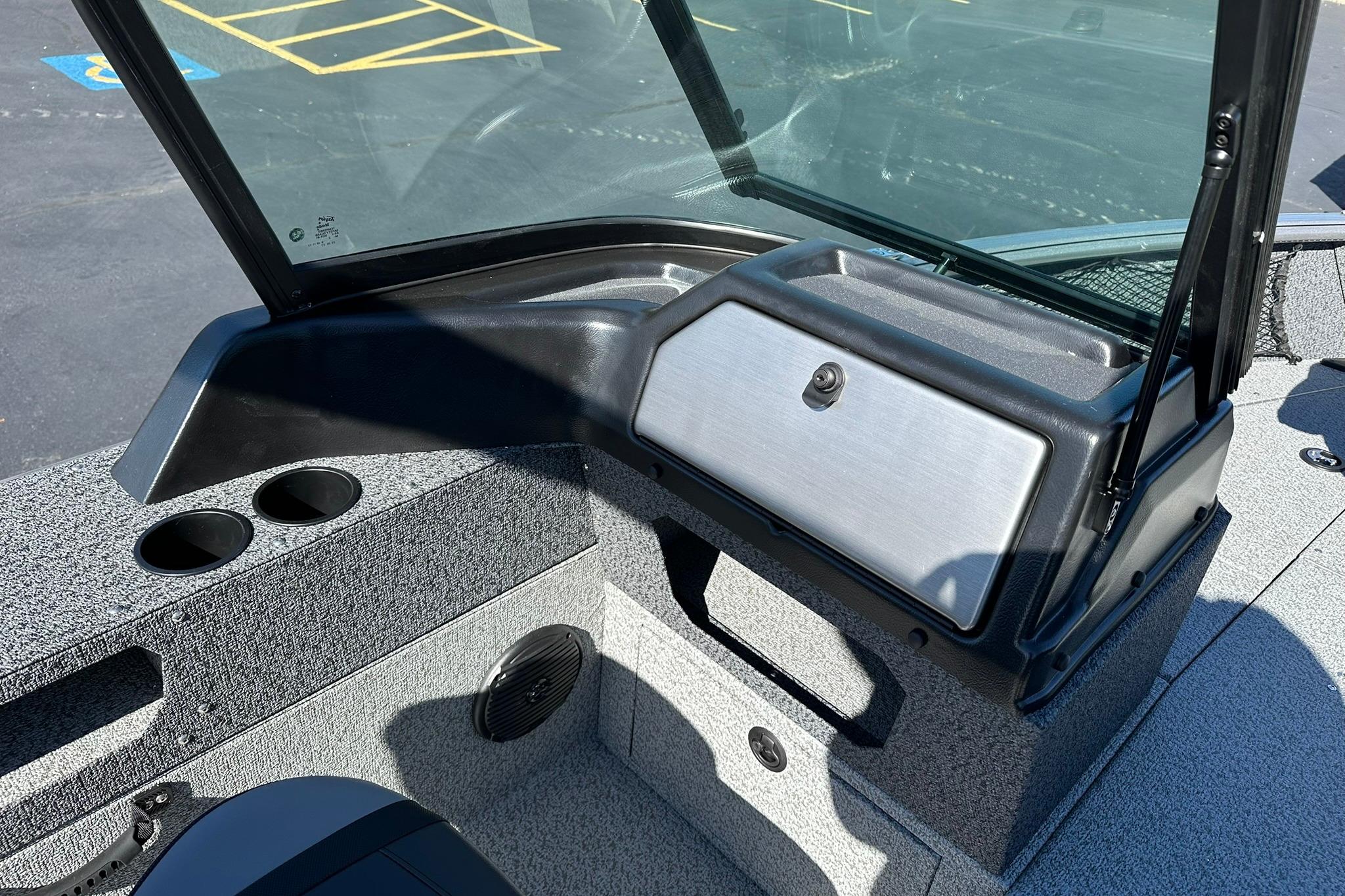 2026 Lund 1875 Impact XS Sport boat interior with windshield and storage compartment.