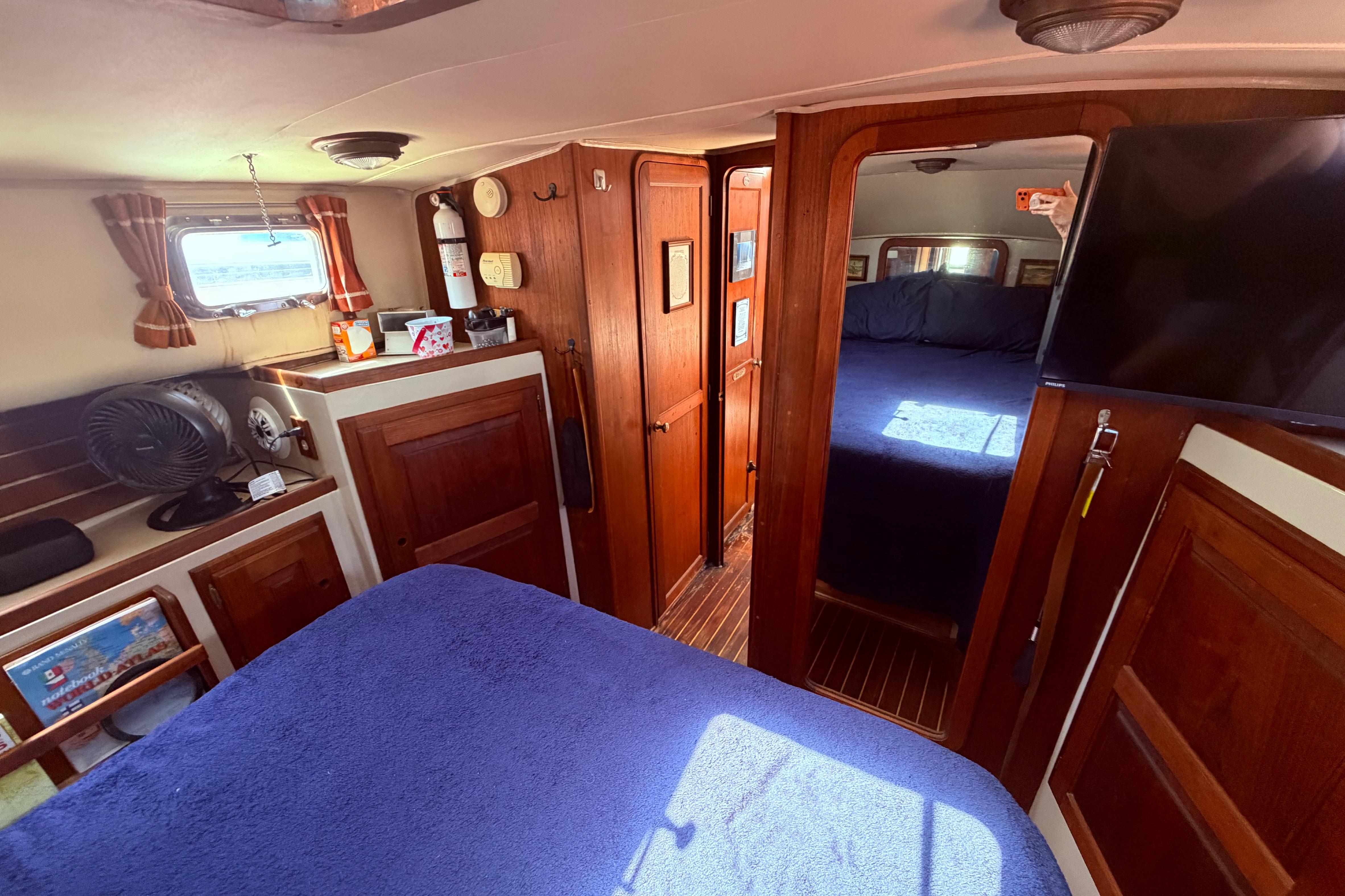 Interior of 1985 Lancer Yachts 40 Motorsailer with wood paneling and cozy cabin.