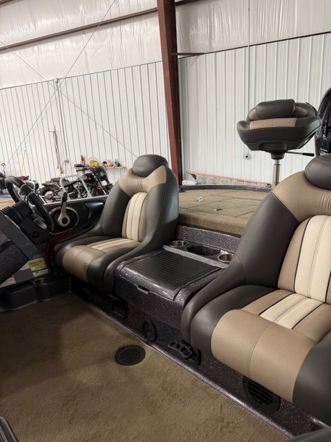 Interior of a 2011 Ranger Z520 Comanche boat with beige seats.
