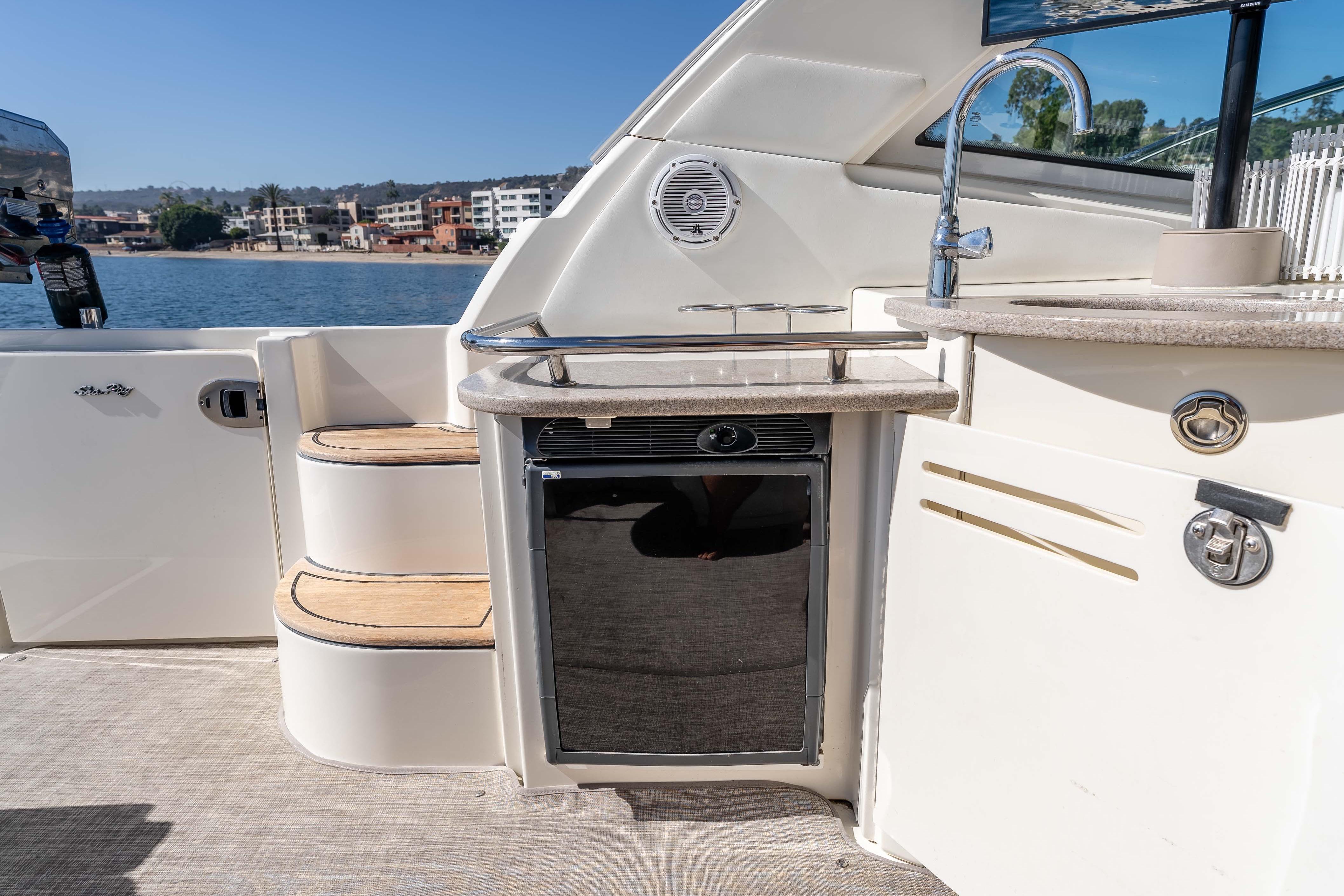 2007 Sea Ray 48 Sundancer yacht deck with kitchenette and scenic waterfront view.