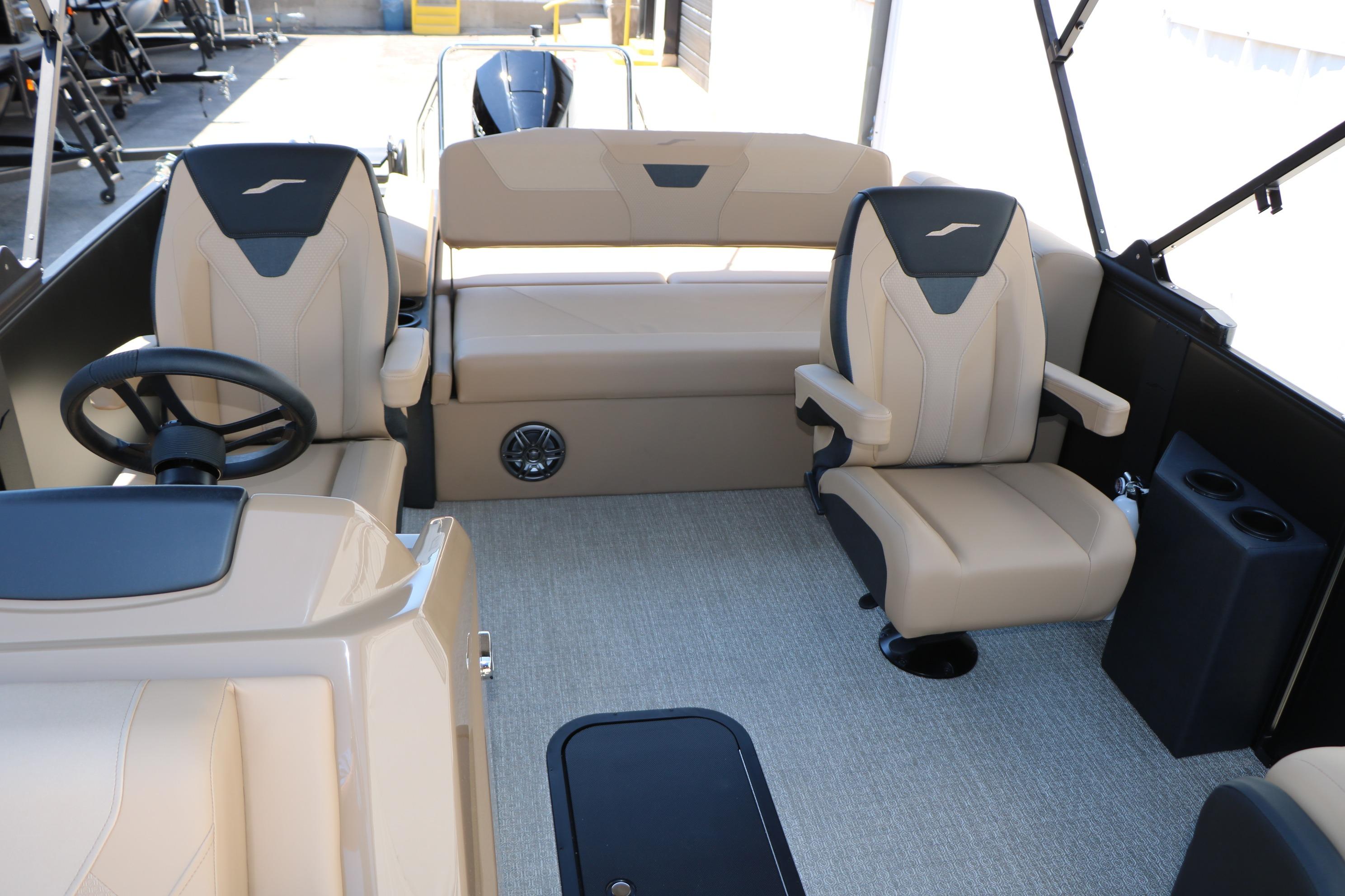 Luxurious interior of 2026 Evotti 521CS boat with beige seating and modern steering.