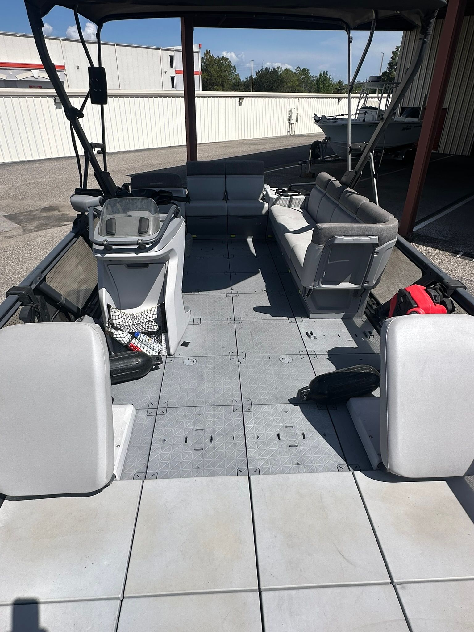 Interior view of a 2023 Sea-Doo 21 SWITCH SPORT with gray seating and open deck.