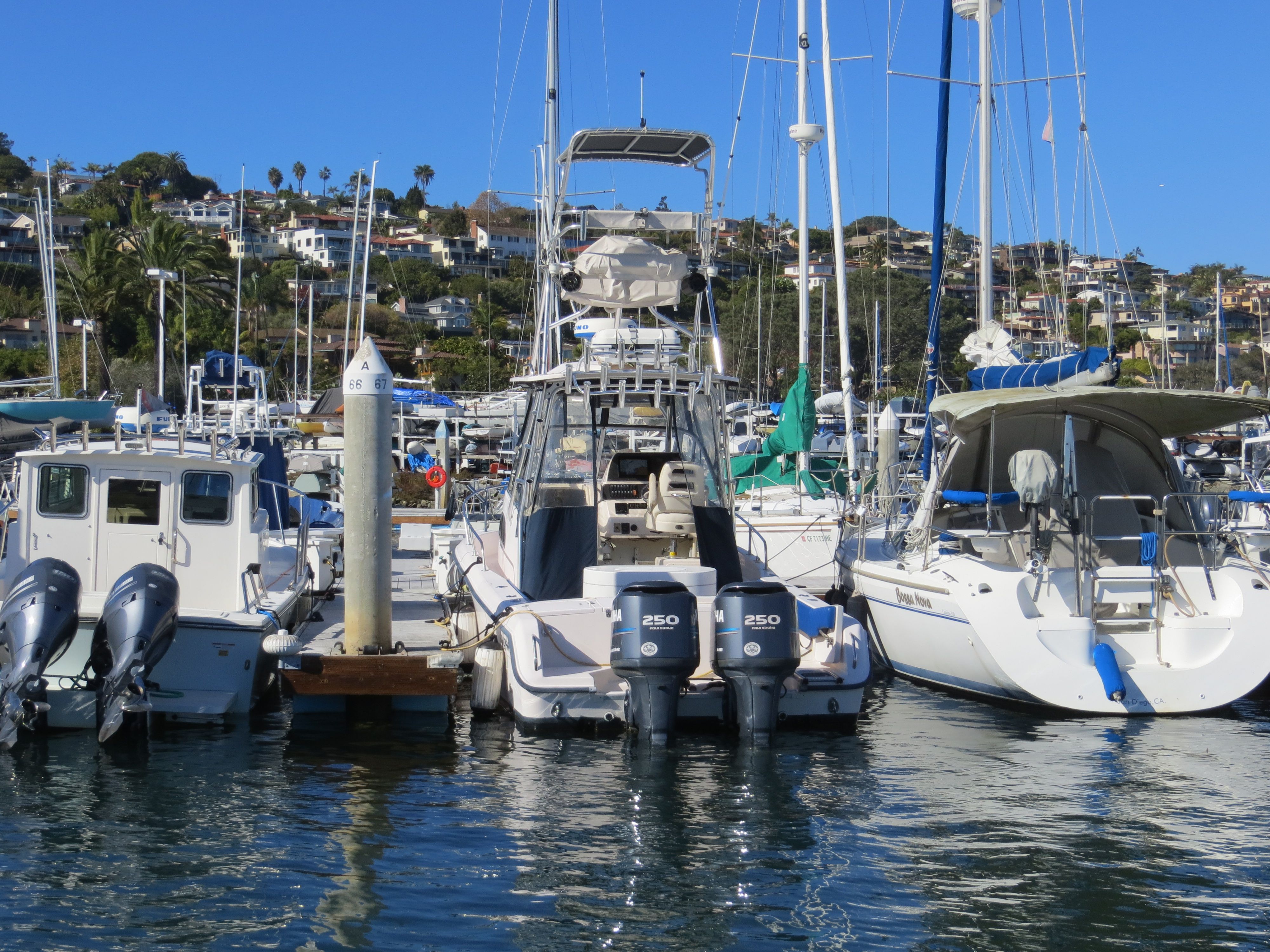 A 2007 Grady-White Sailfish 282 docked in a marina, surrounded by other boats.